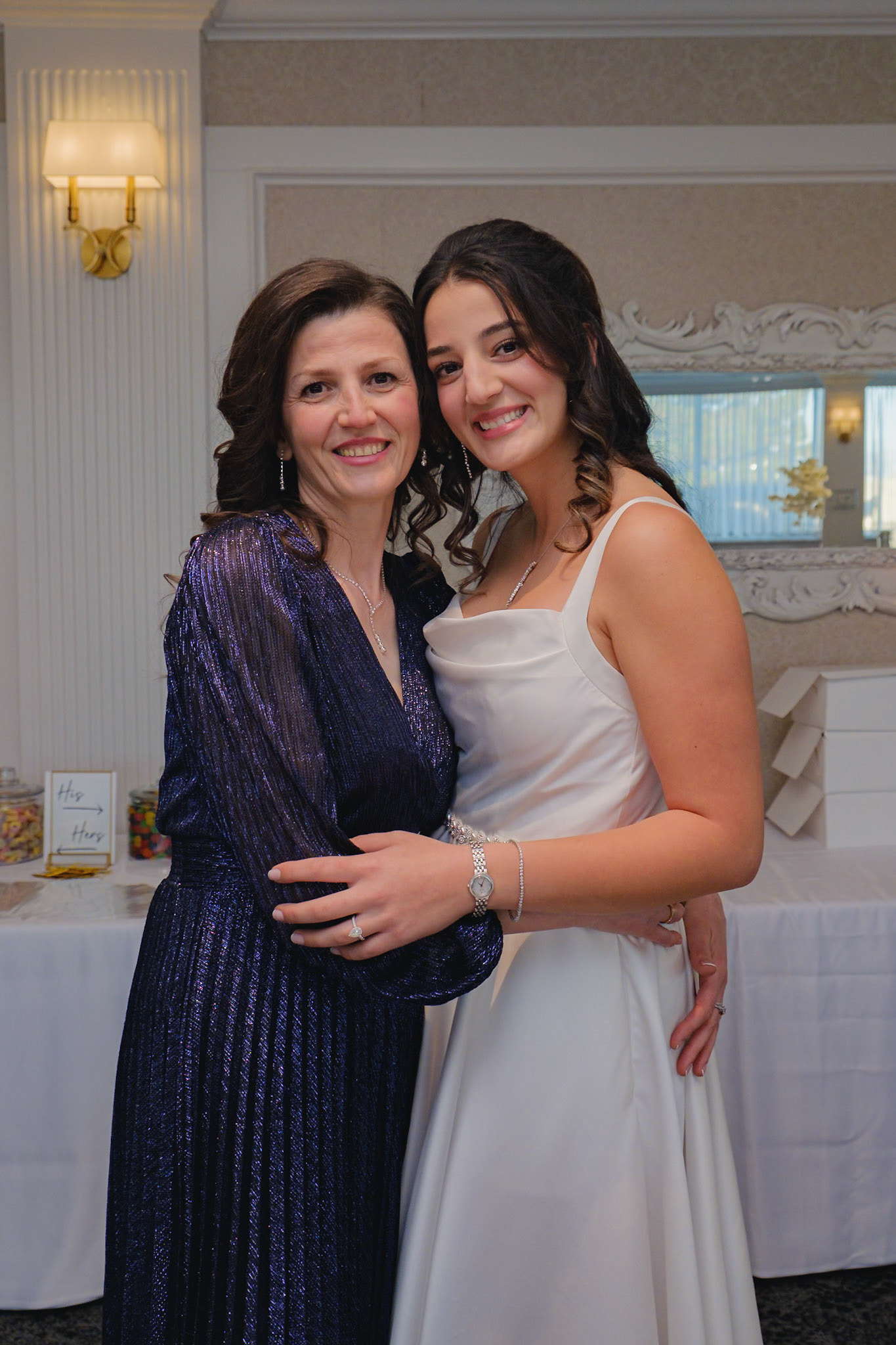 Bride with her mother smiling during family photos at Toronto engagement party