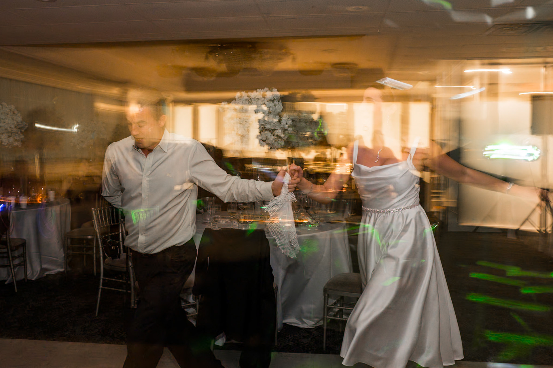 Artistic motion blur of couple dancing under dim lights at Toronto engagement party