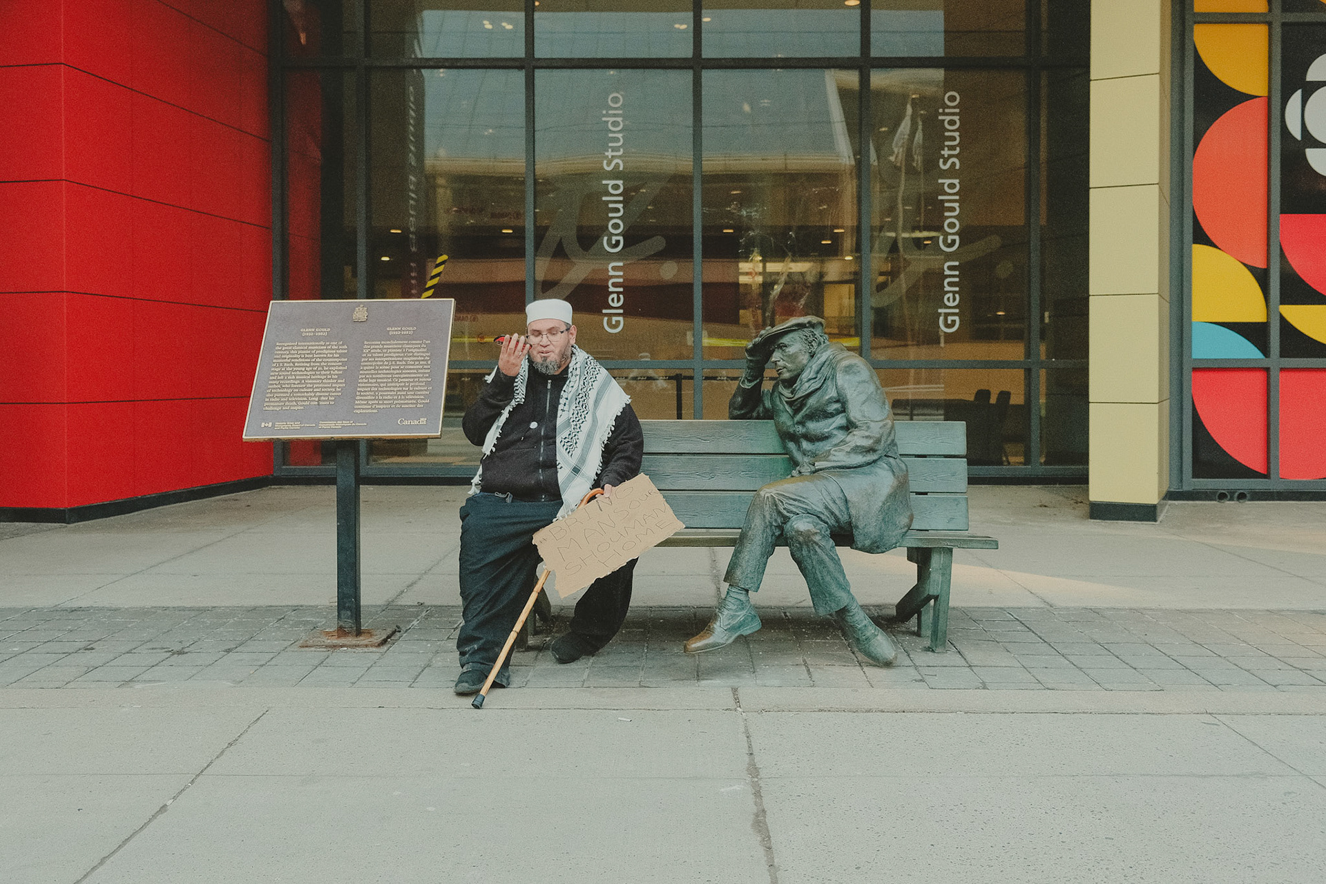 Assistant resting after a Pro-Palestine rally in Toronto, seating in a bench with protest banners in the Hand. Urban journalism highlighting voices for justice.