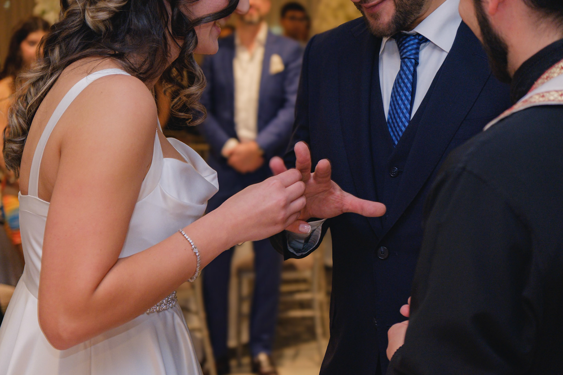 Bride placing engagement ring on groom’s finger during ring exchange at intimate Toronto celebration