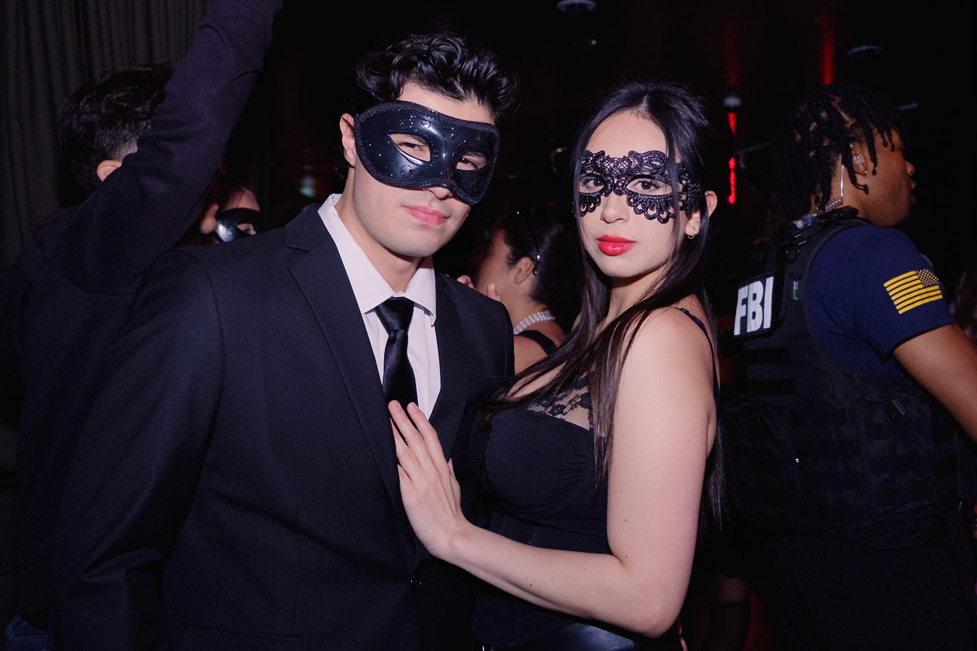 Guests in costume dancing under dramatic lighting at a Halloween party in a Toronto nightclub