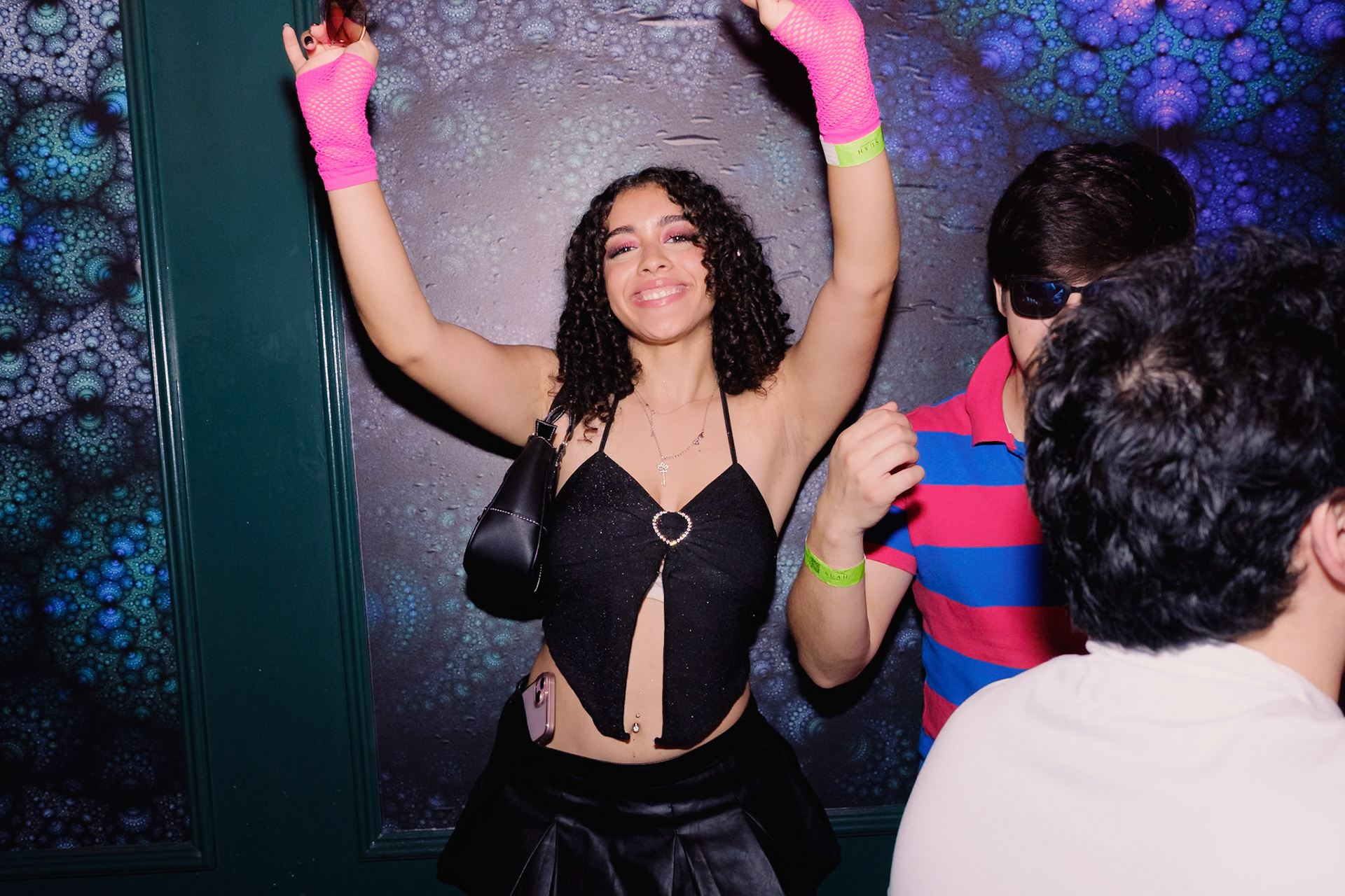 Guests in costume dancing under dramatic lighting at a Halloween party in a Toronto nightclub