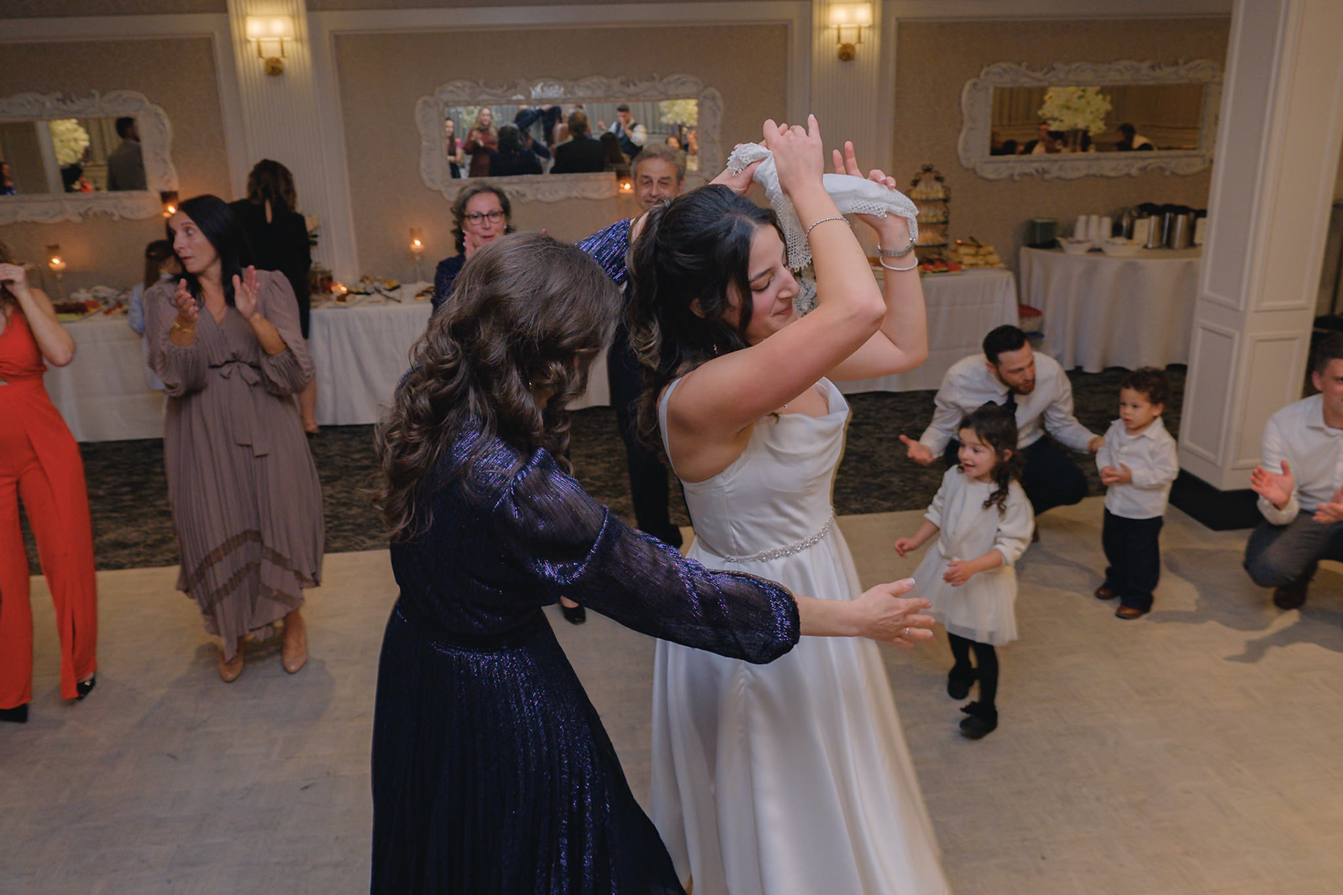 Guests dancing and interacting joyfully during traditional celebration at Toronto engagement party