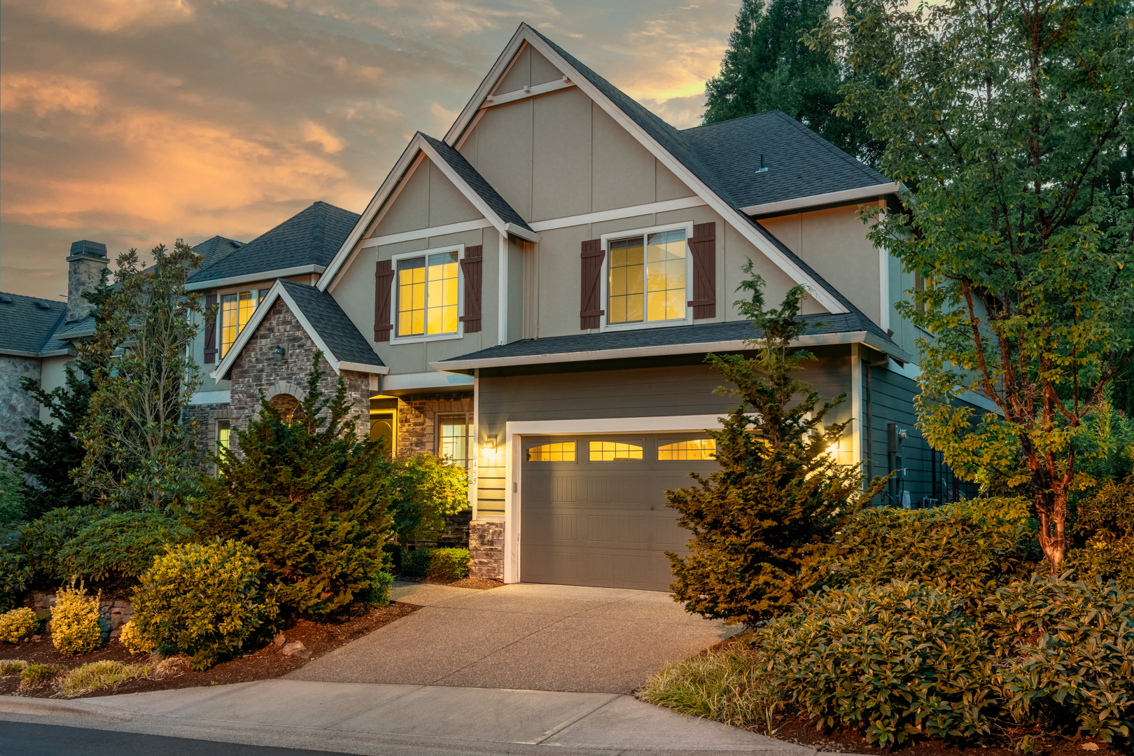 Stunning twilight photograph capturing a home’s exterior with glowing windows and rich sky hues—ideal for showcasing evening ambiance.