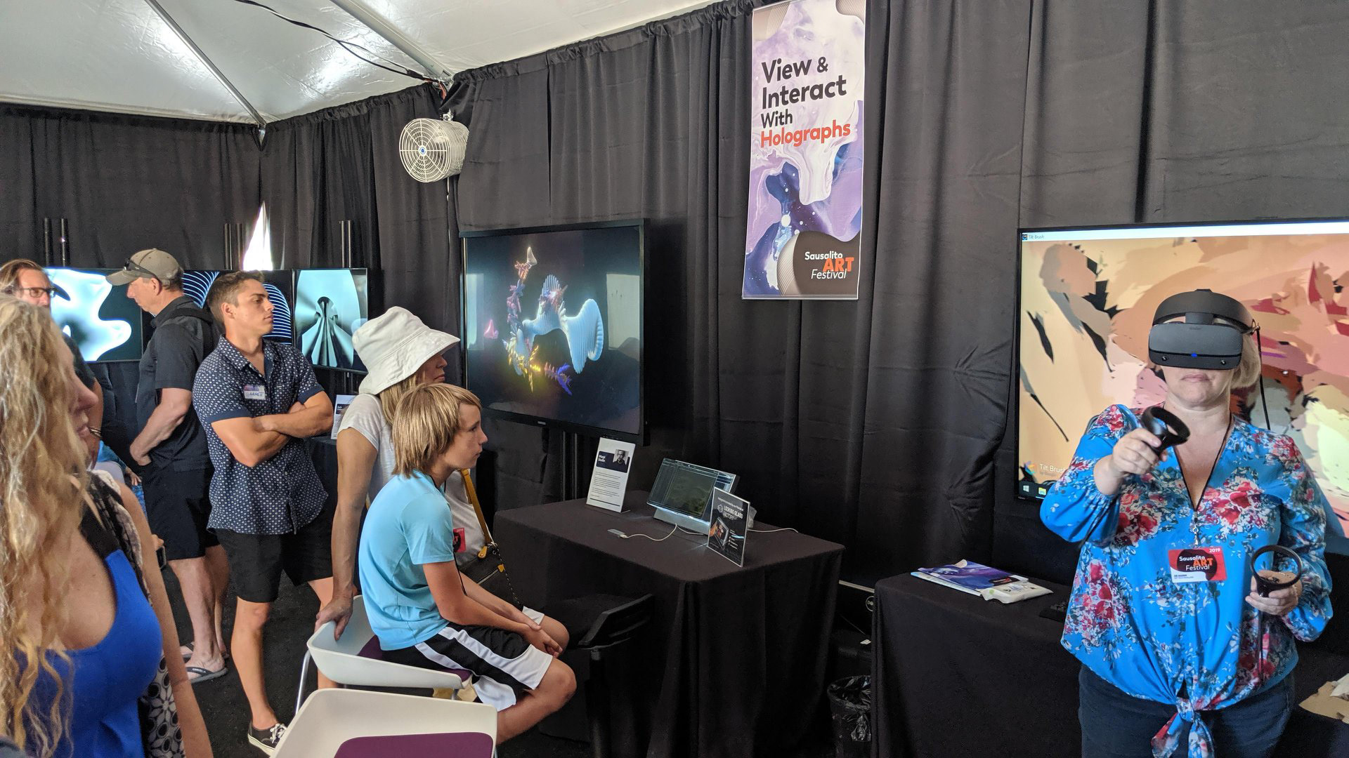 Live demo painting in Virtual Reality by artist Lisa Padilla adjacent to the Looking Glass holographic display, artist Marpi’s Wave Atlas AI interactive touch screen and artist Zach Lieberman’s Art + Code in synch triptych video wall.