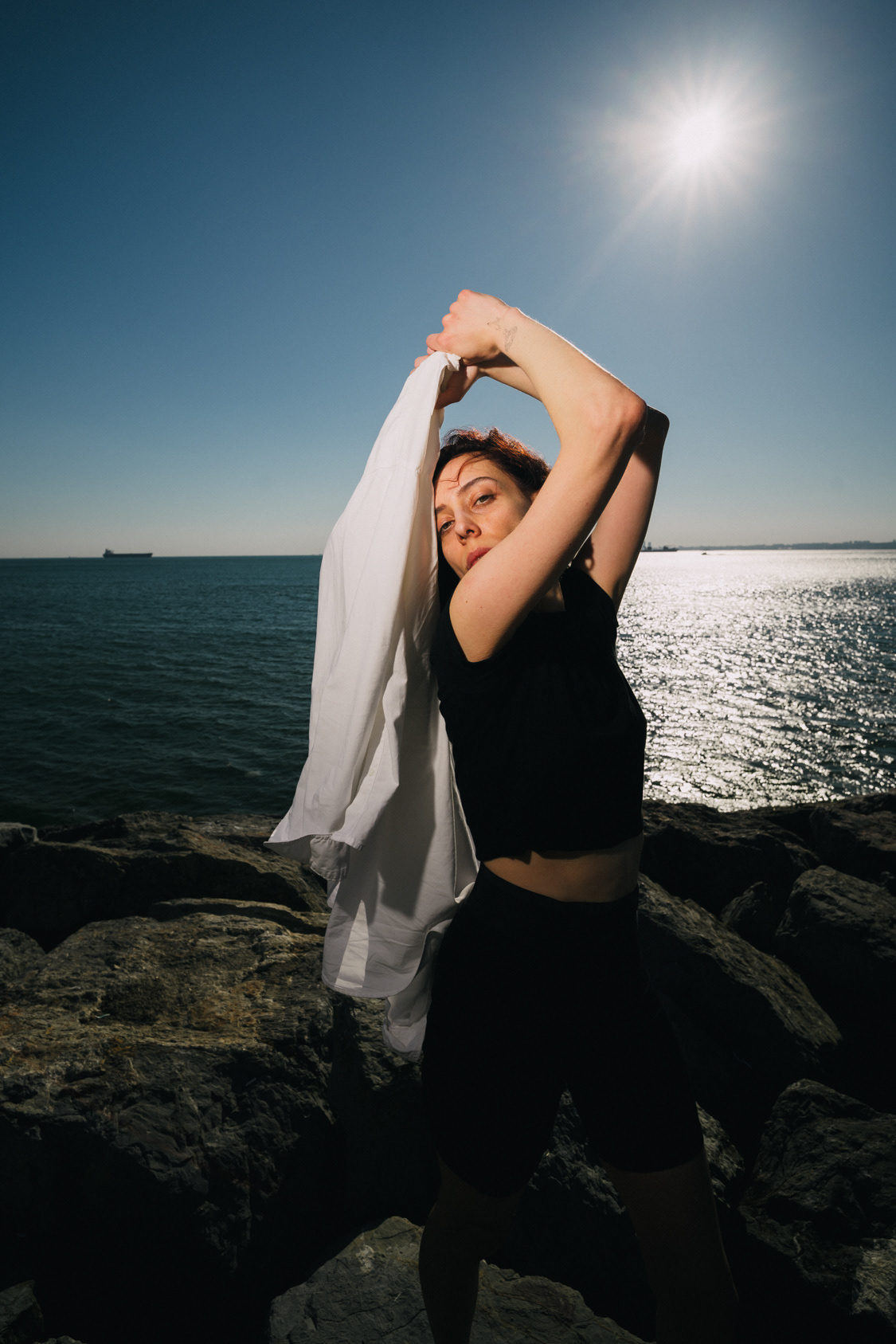 Windswept portrait with flowing white fabric by the Bosphorus in Istanbul