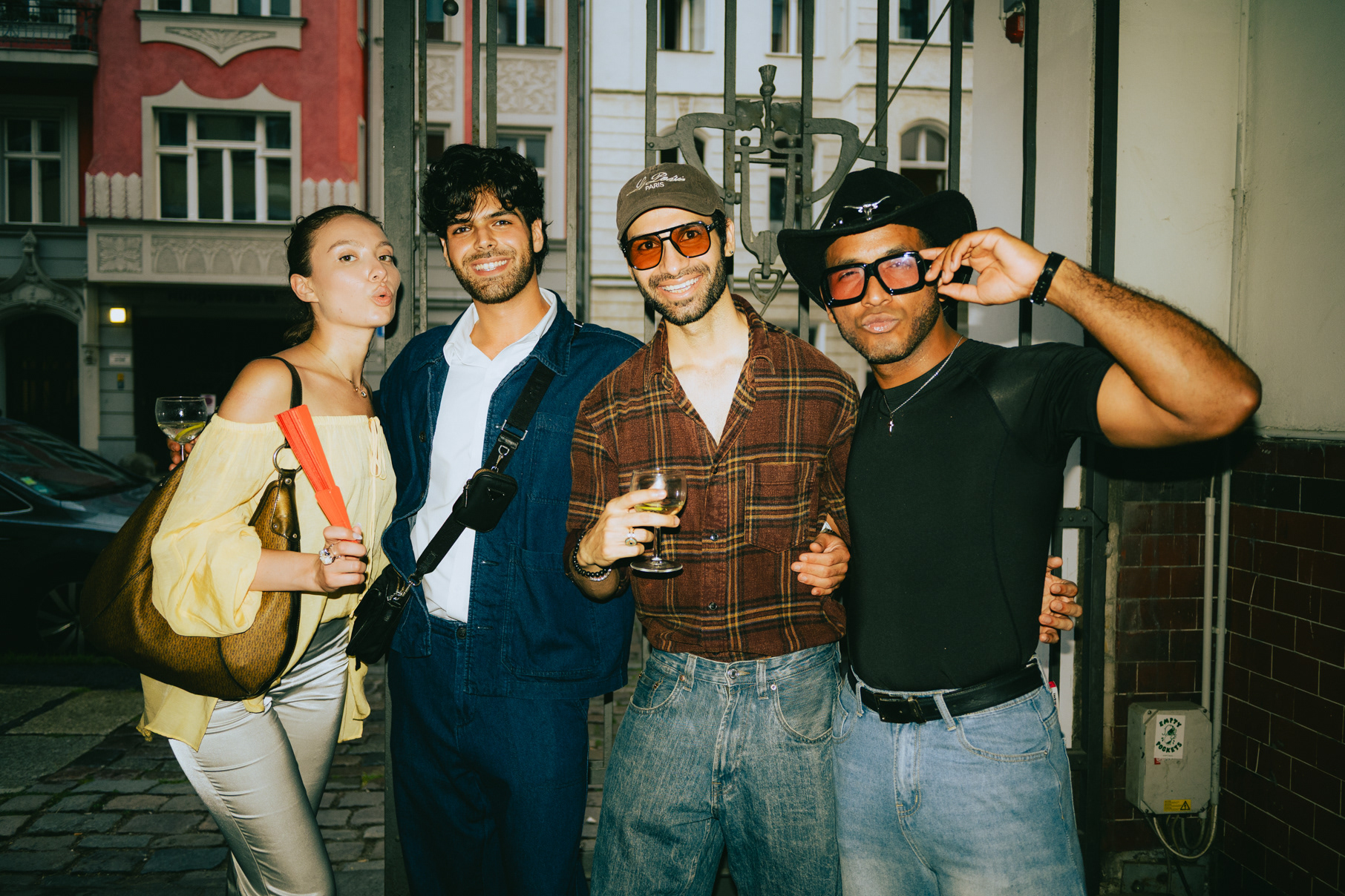 Group of friends in colourful streetwear posing together at a Berlin fashion event