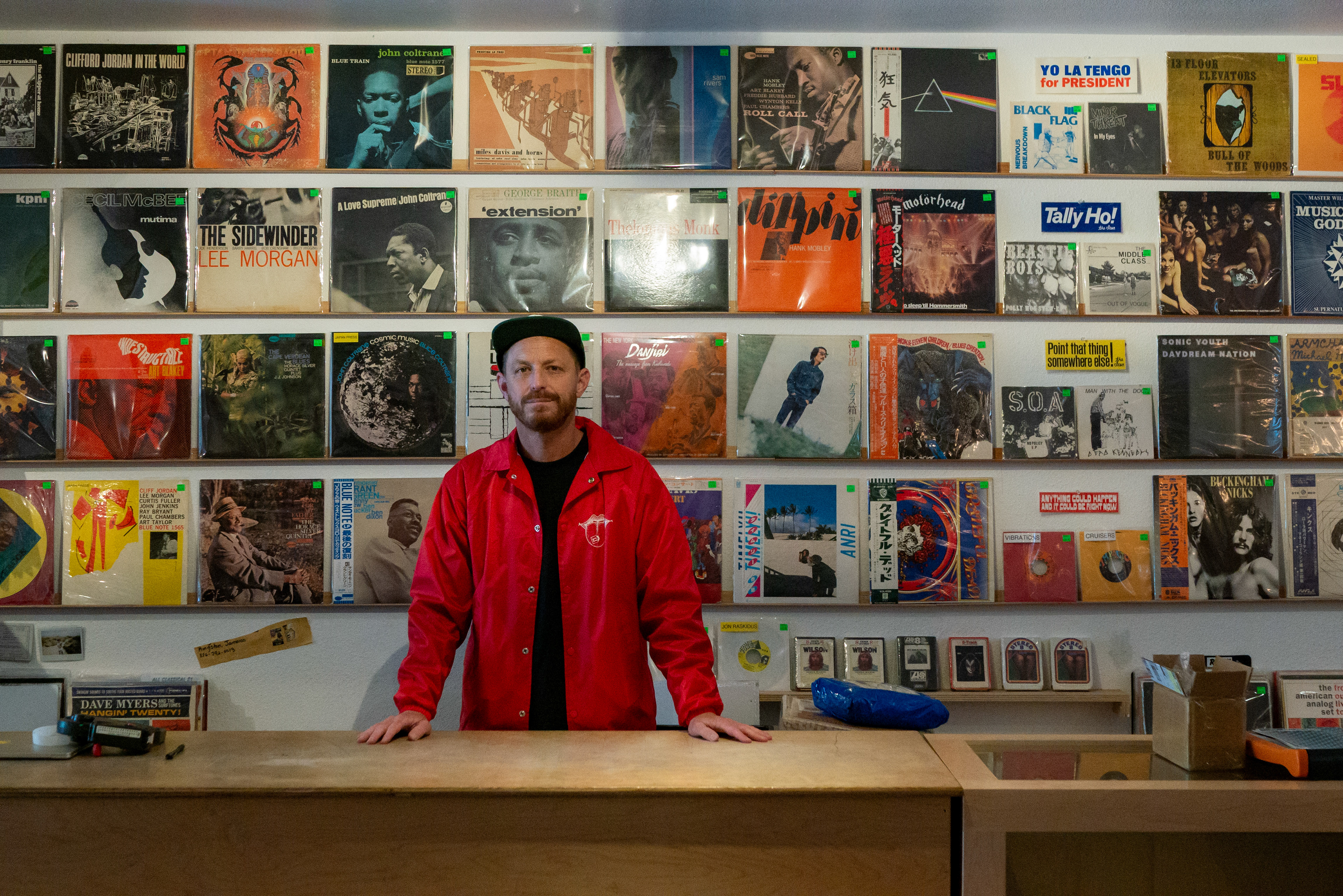 Ben Wintroub, owner of two Tunnel Records stores – one on Taraval Street near the beach, the other in the annex adjoining the 4-Star Theater on Clement Street –  stands in front of his ever-changing inventory of vinyl records on June 14, 2024. (Klyde Java for the Richmond Review/Sunset Beacon)