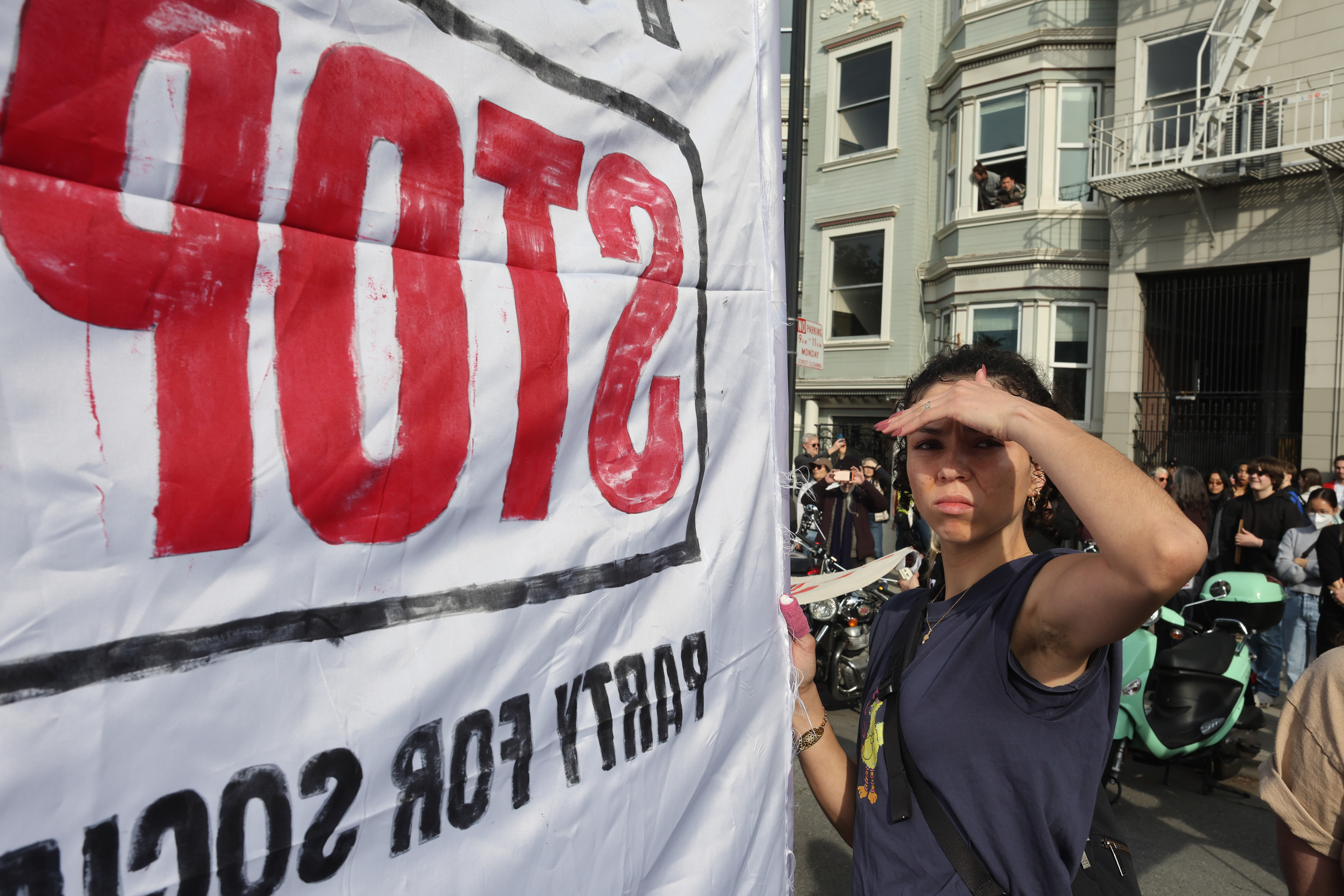 A protester with the Party for Socialism and Liberation shields her eyes from the sun during the ICE Out protests in San Francisco, Calif. on Jan. 30, 2026. Photo by Klyde Java.