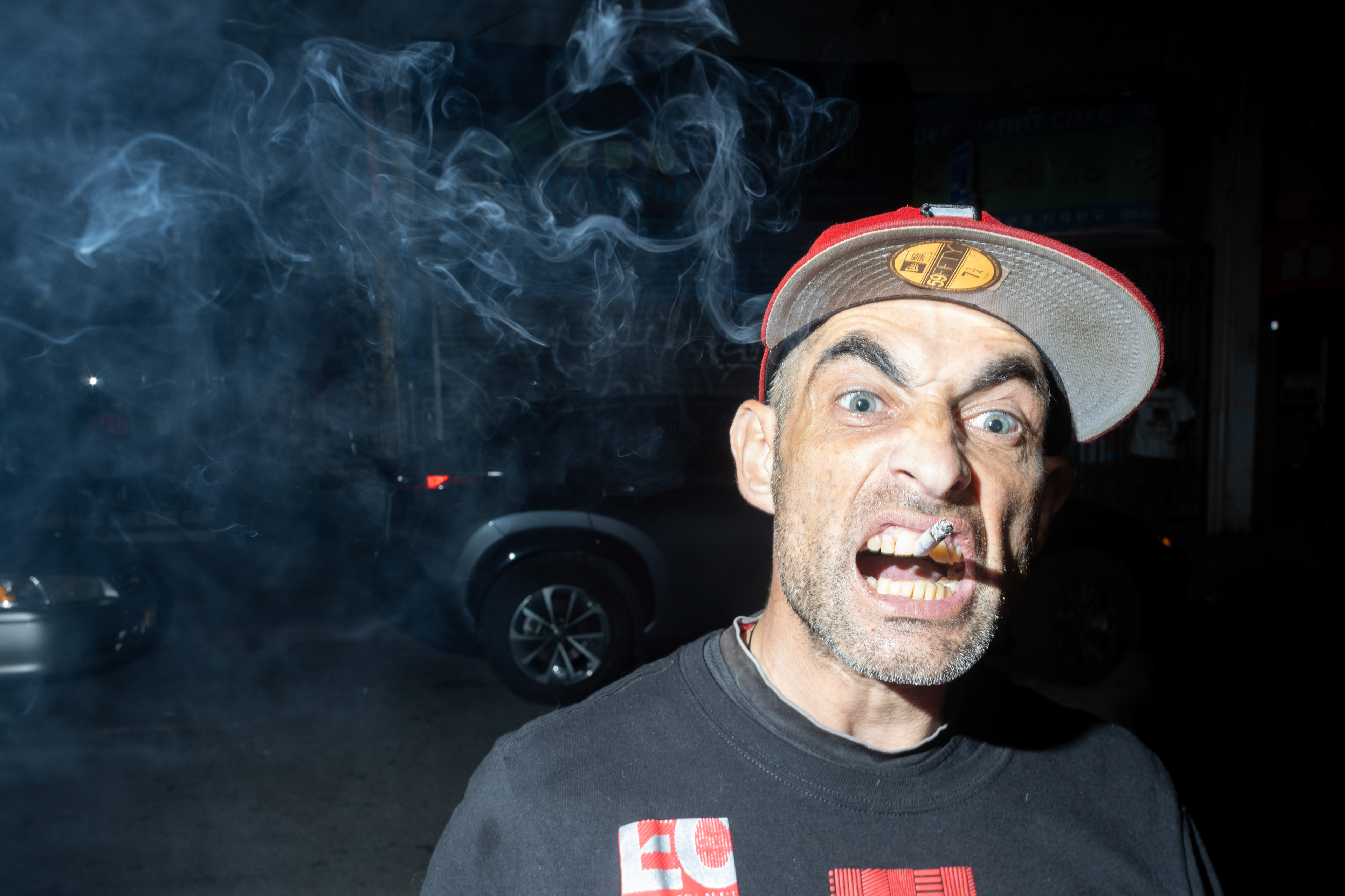 Preston, the bouncer of Chinatown's Lipo Lounge, lives up to his "Smoker" nickname as he sticks a cigarette between his teeth. (Klyde Java special to Xpress Magazine)