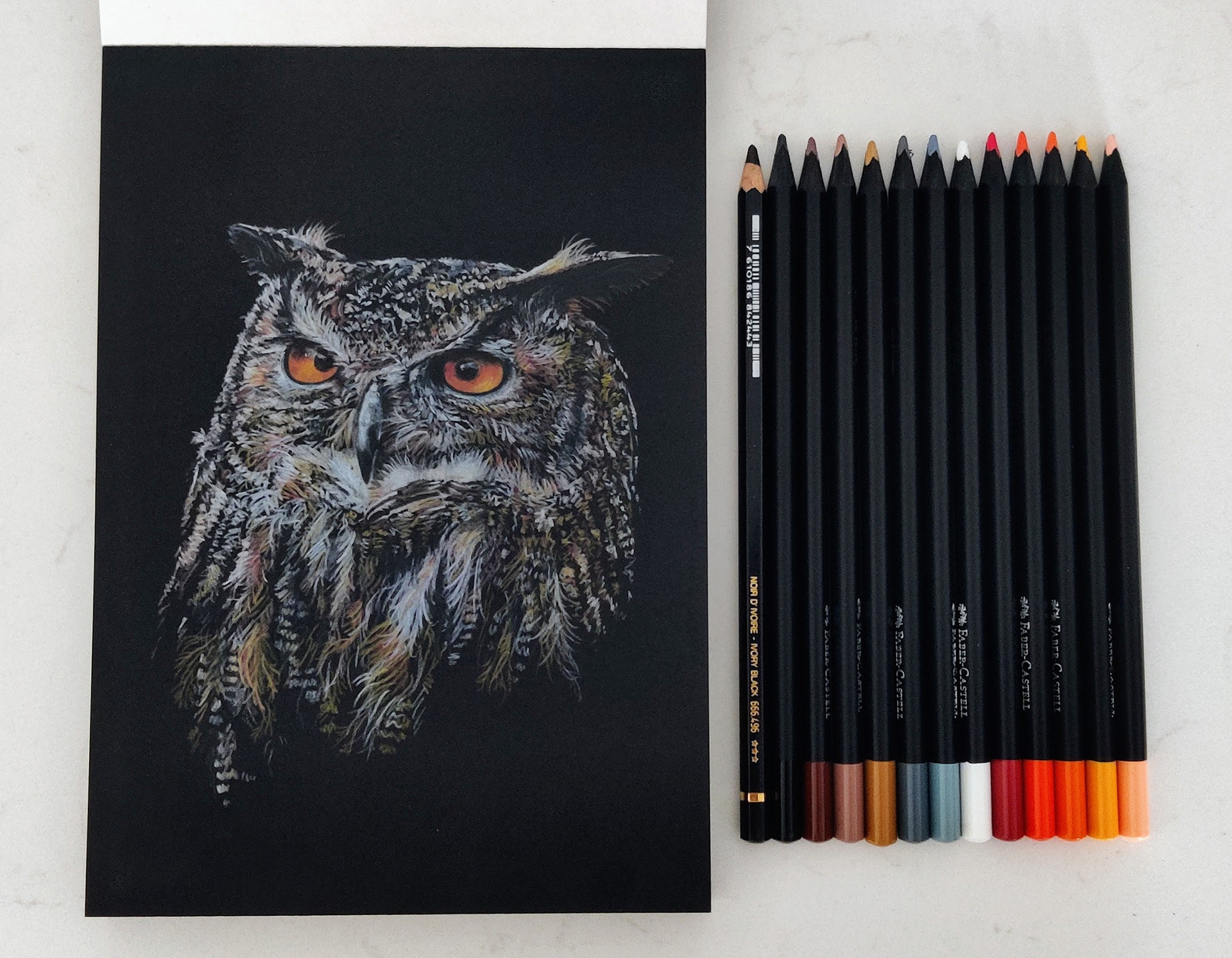 An eagle owl on A5 black paper