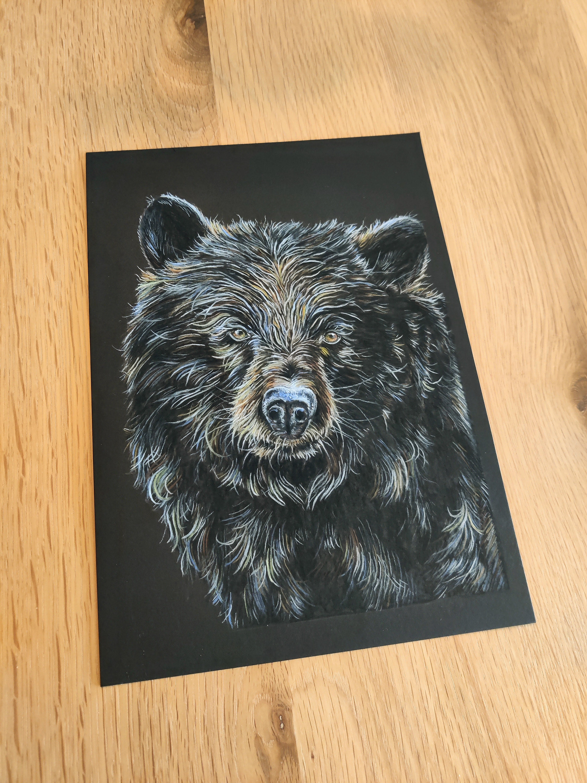 A black bear on A4 black paper