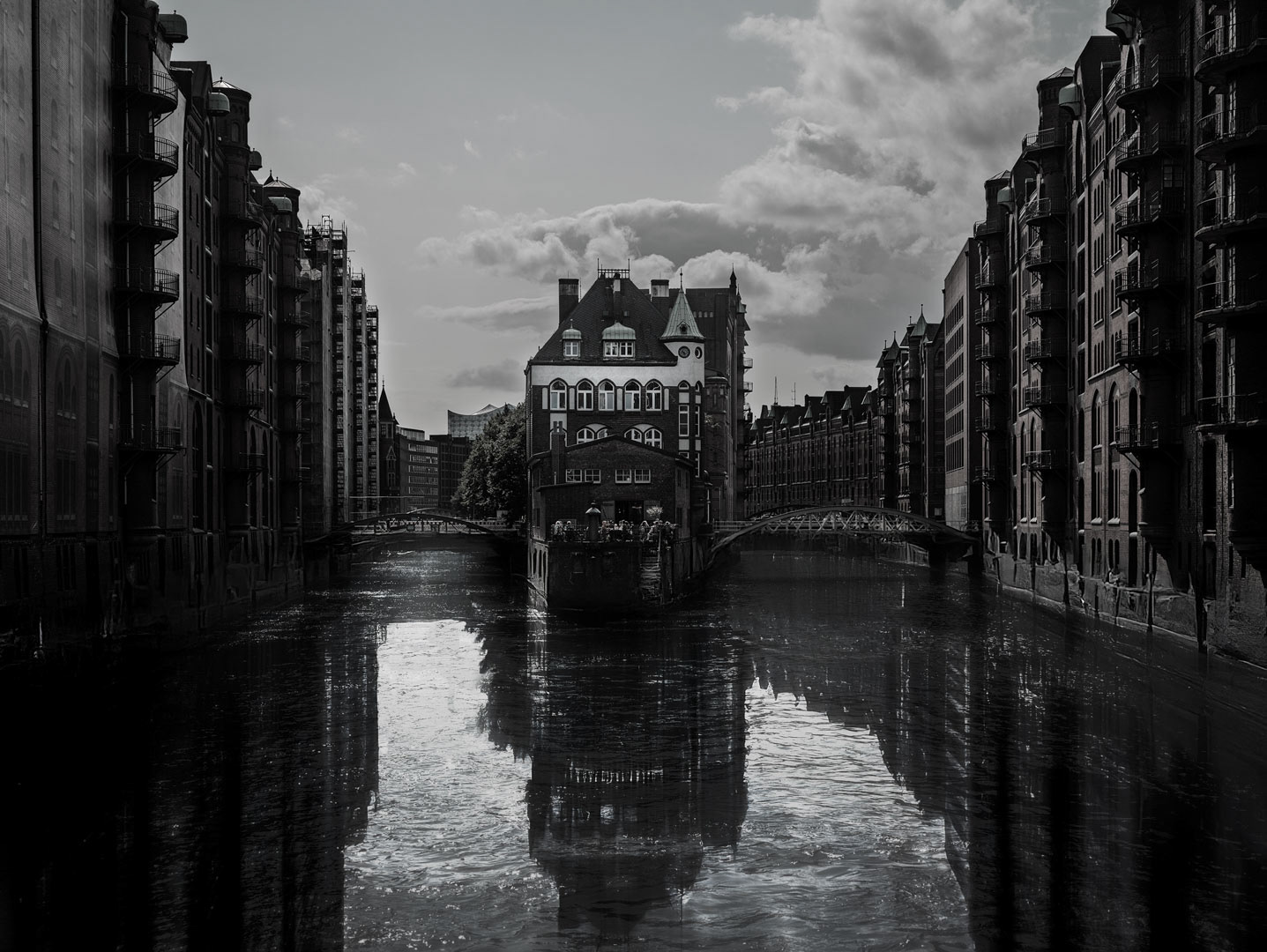 Canal Reflections — Warehouse walls mirrored in still water, Hamburg Speicherstadt.