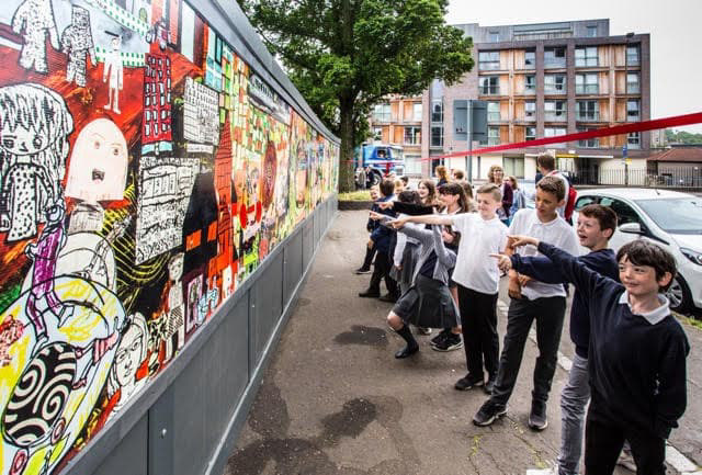 the kids pointing out their characters and drawings.