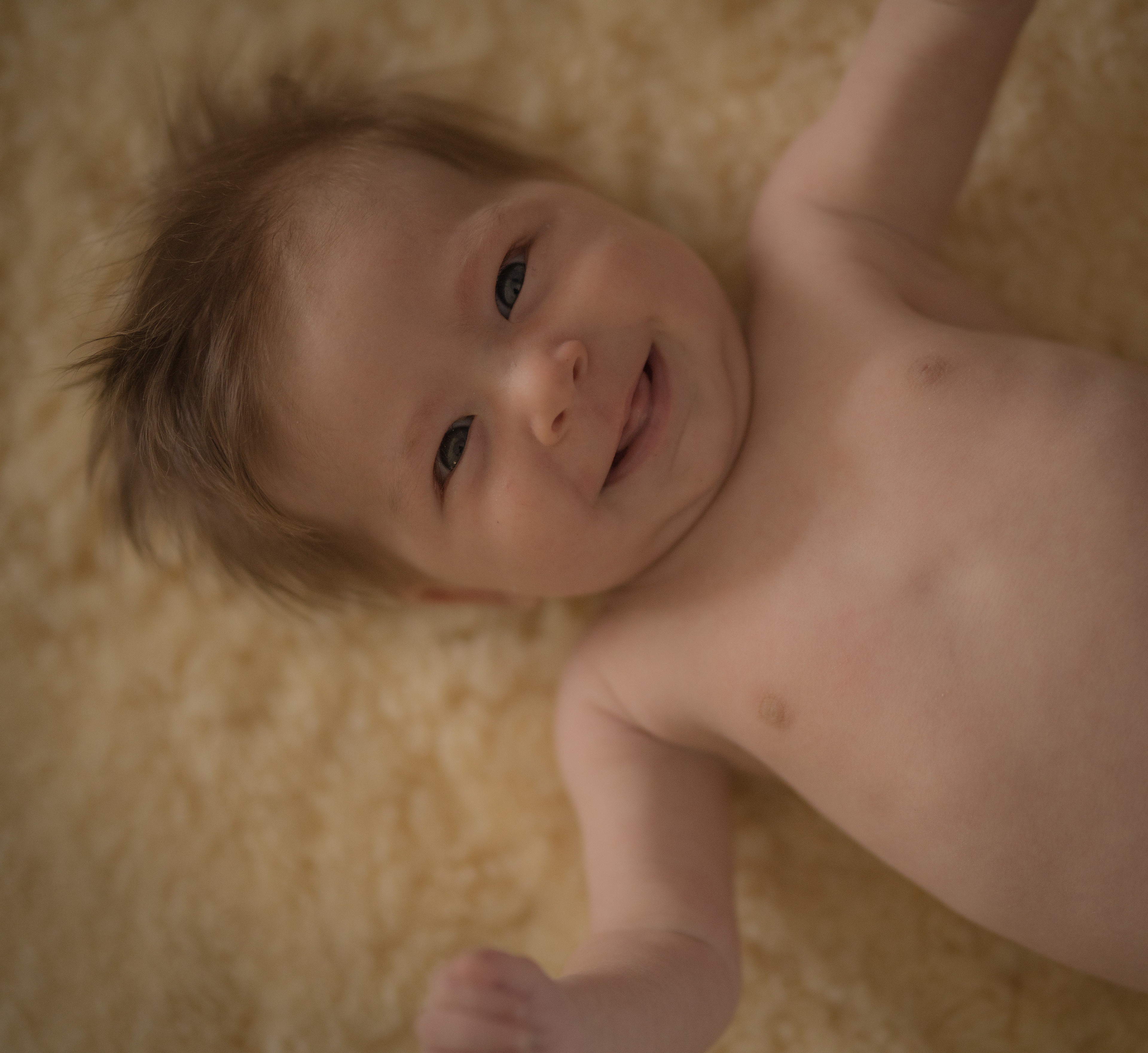 Veronika Rauch - Baby auf Fell am lachen