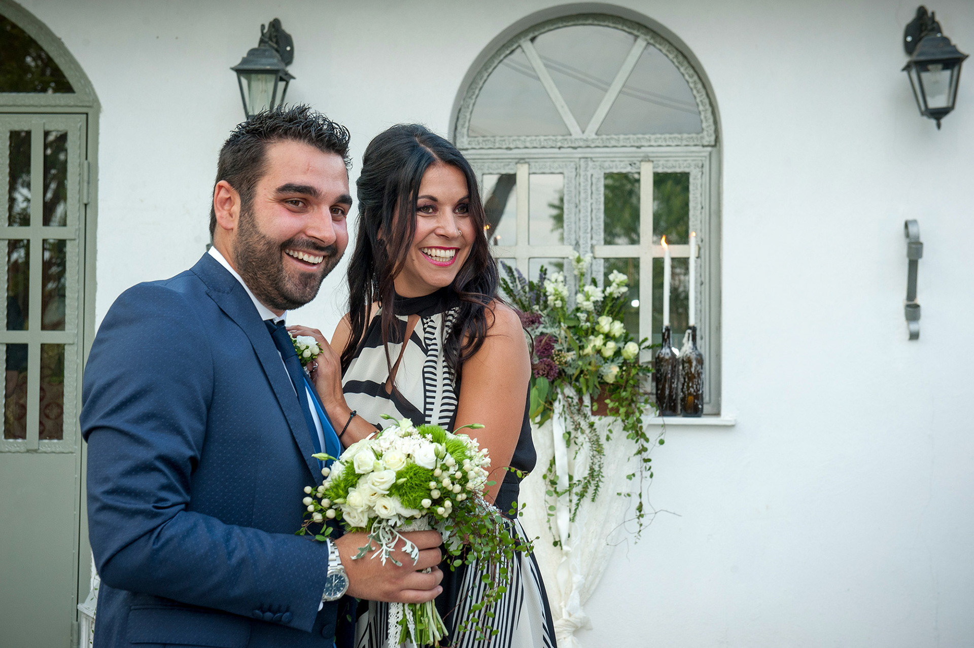 Ο γαμπρός και η αδελφή του χαμογελούν μπροστά από την εκκλησία, λίγο πριν τον γάμο.     The groom and his sister smile in front of the church, just before the wedding ceremony.