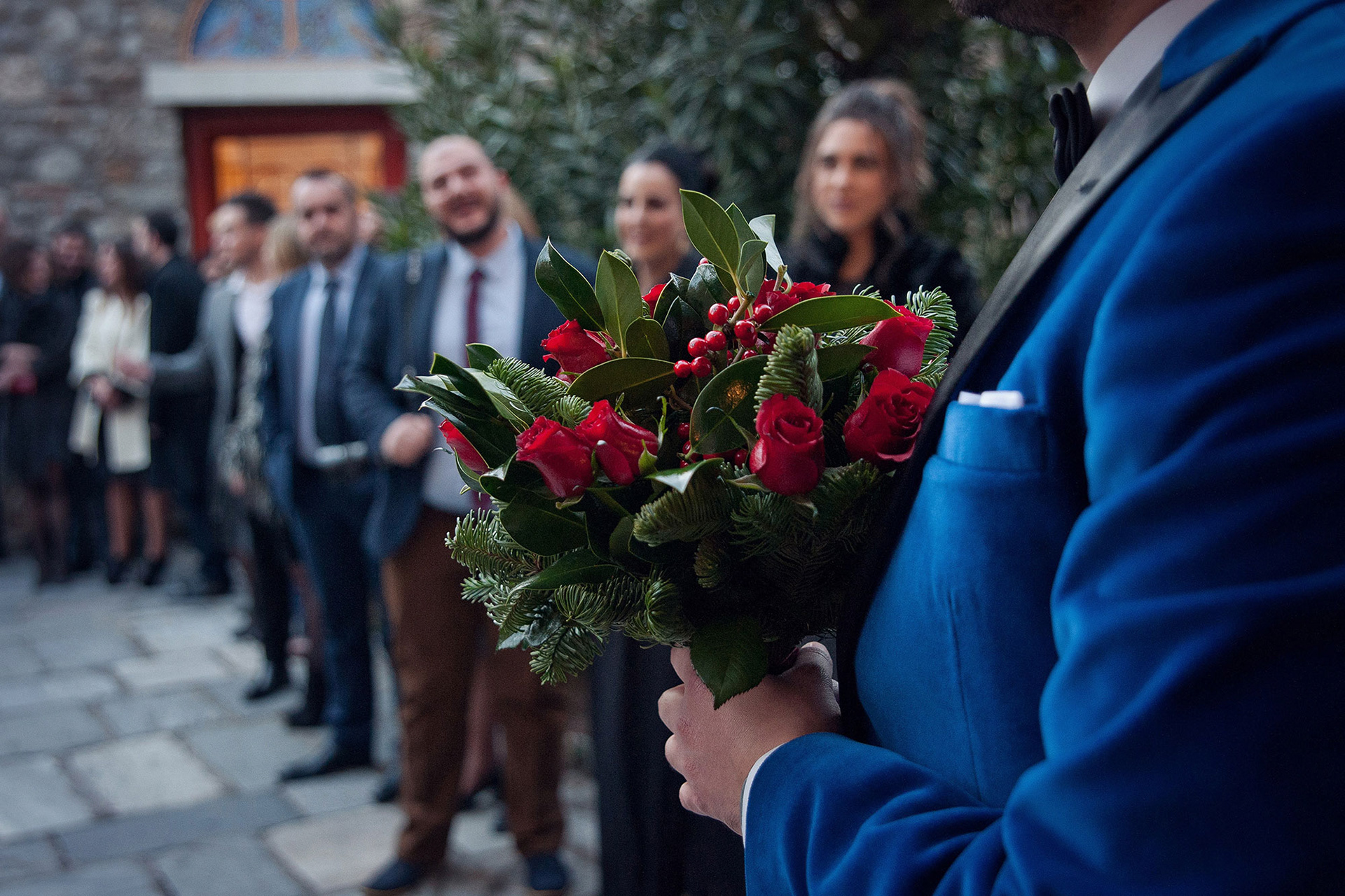 μπουκέτο νυφικό που κρατάει ο γαμπρός έξω από την εκκλησία