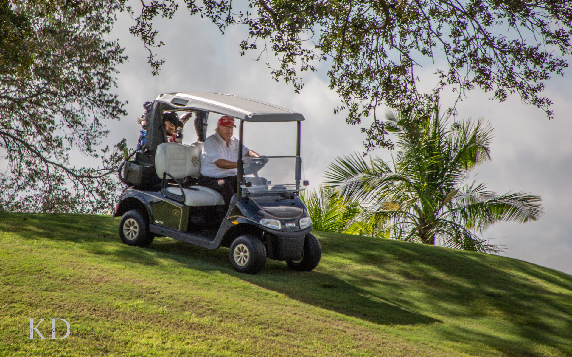 Trump CC WPB FL of Donald Trump driving his golf cart