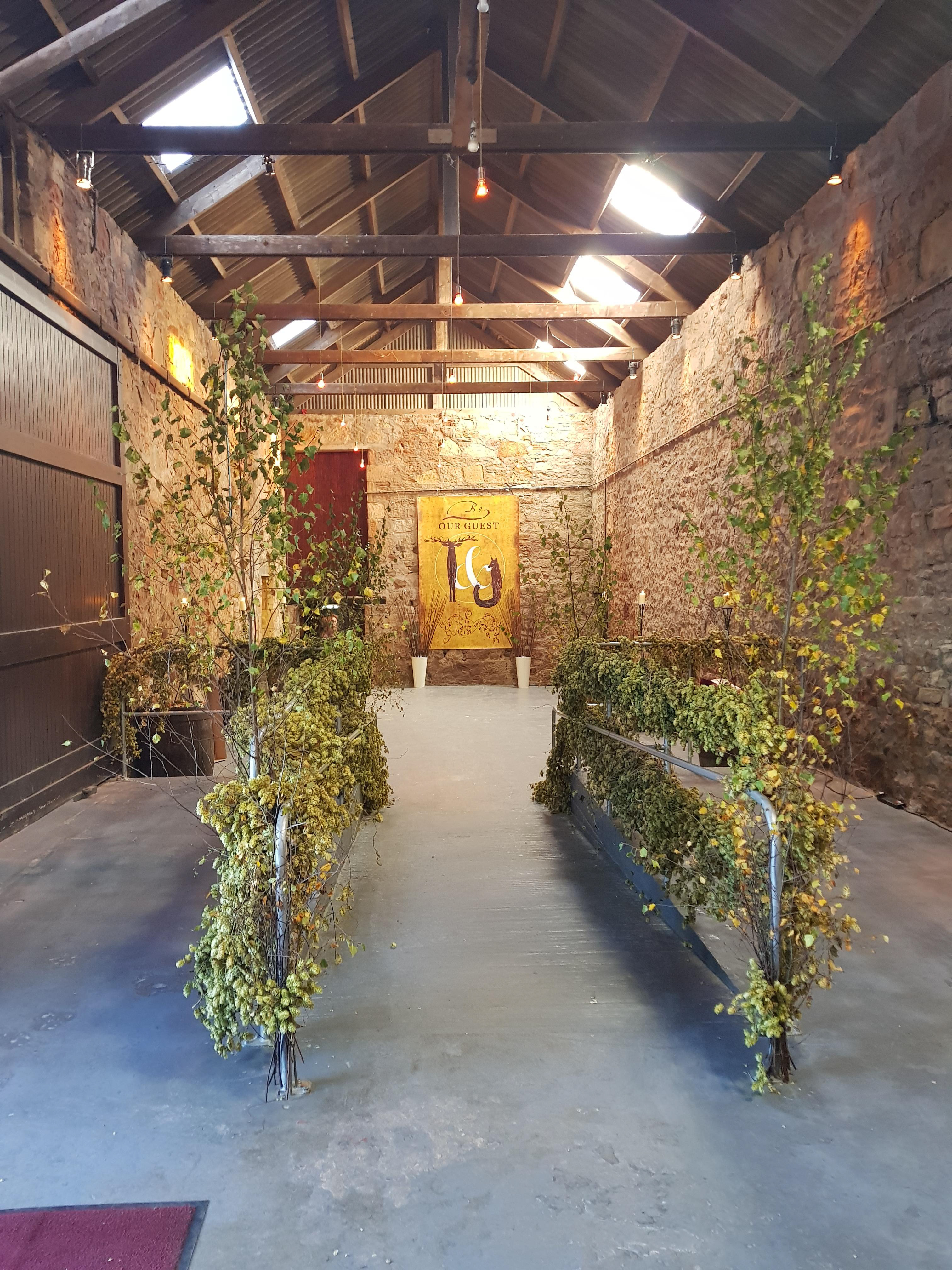 Byre decorated with dried hops and tree branches