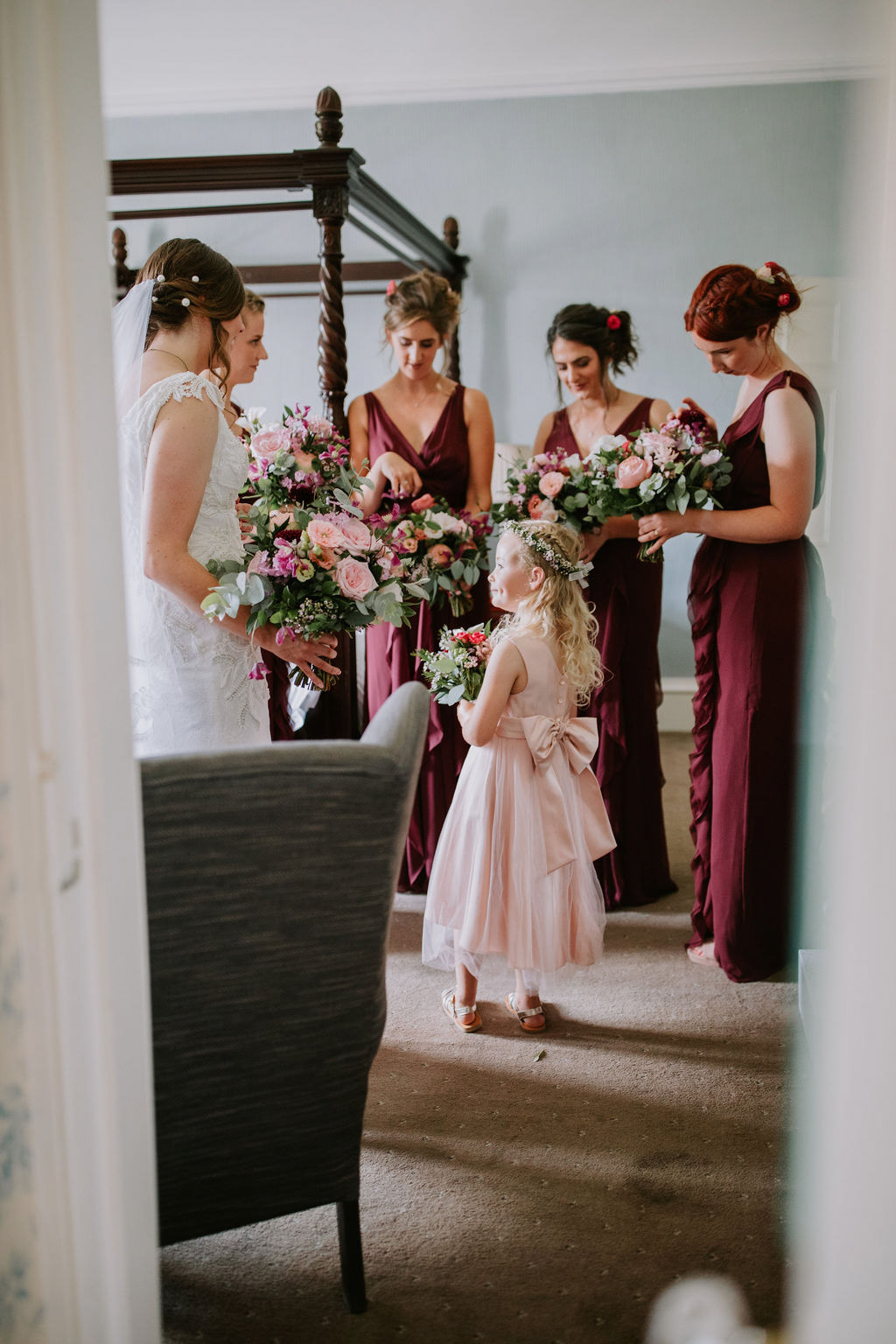 bridal party looking at their wedding bouquets