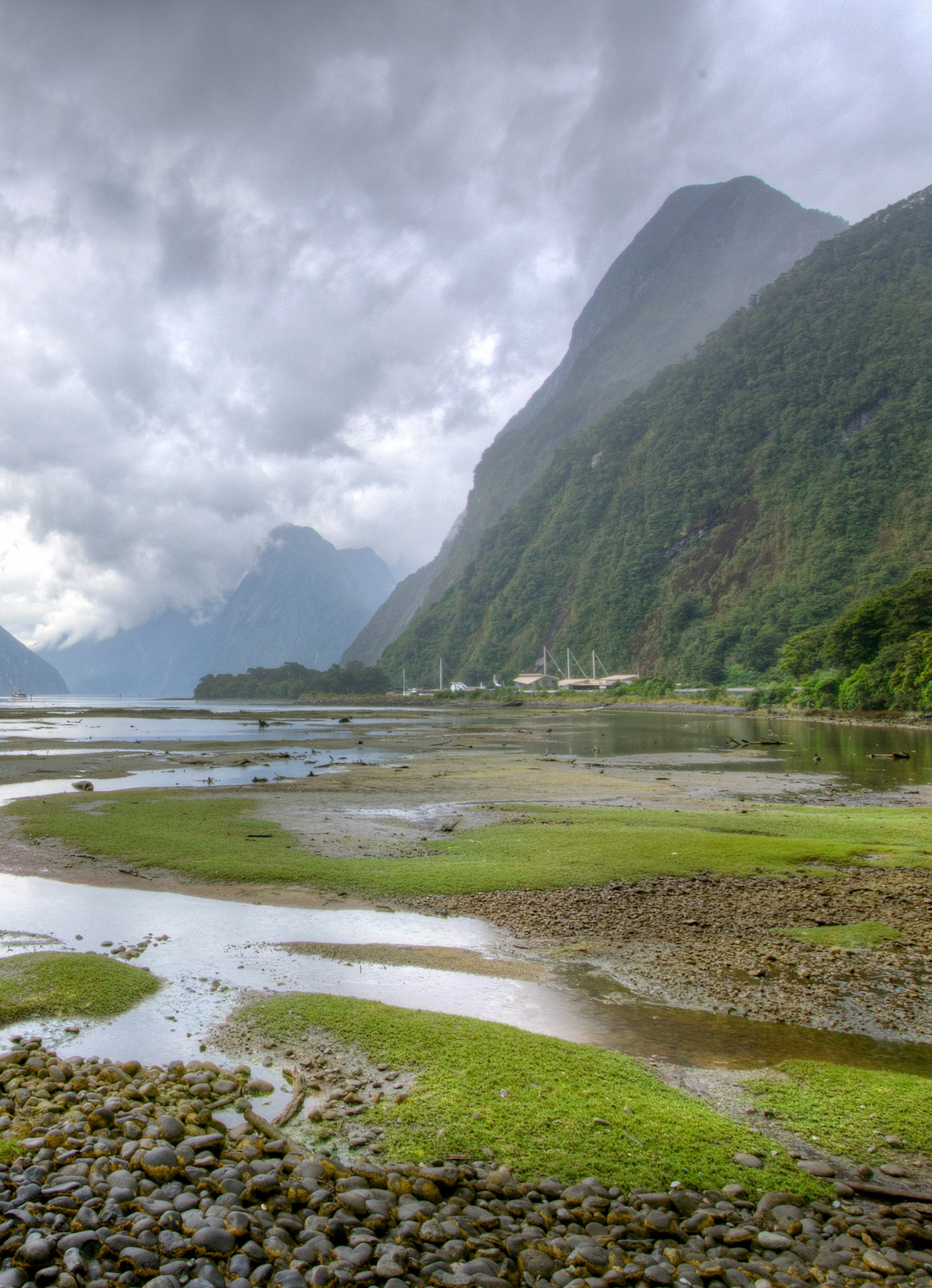 Milford Sound, NZ - View from the walkway with the sun poking through the sky