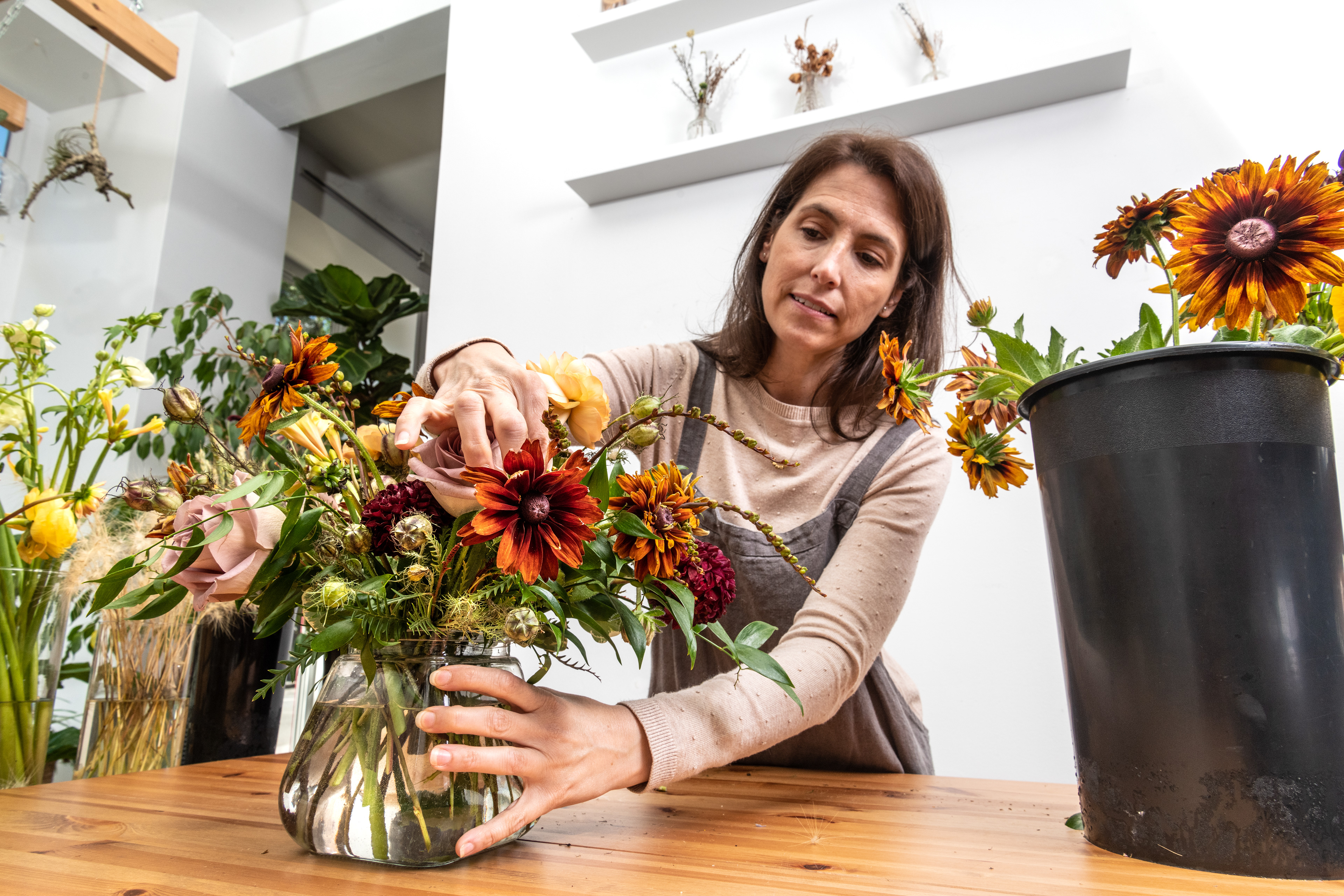 Cortney Sedor working on the floral arrangement.