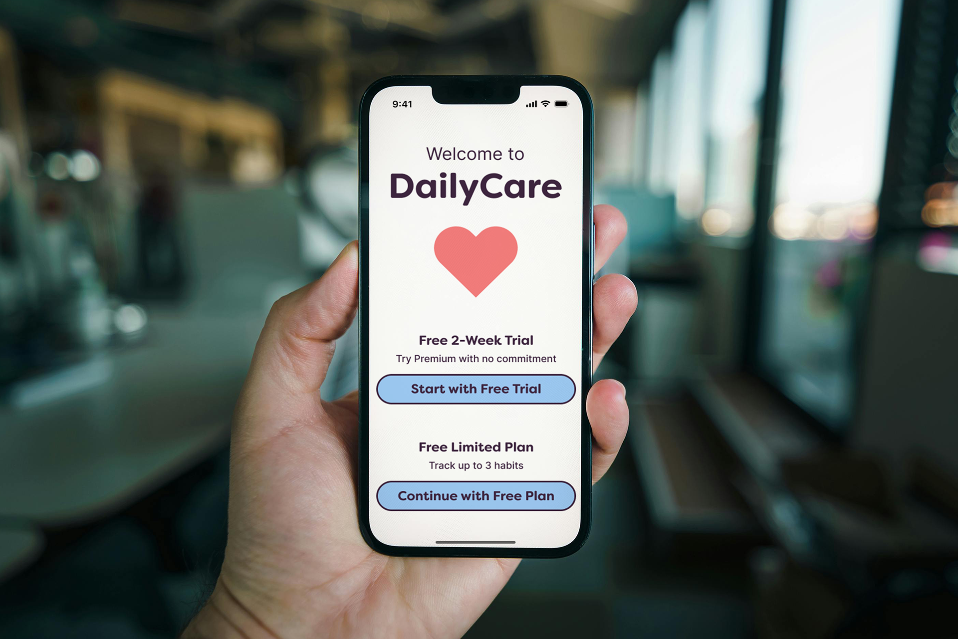 DailyCare app pricing screen on phone showing free two-week trial and free limited plan options