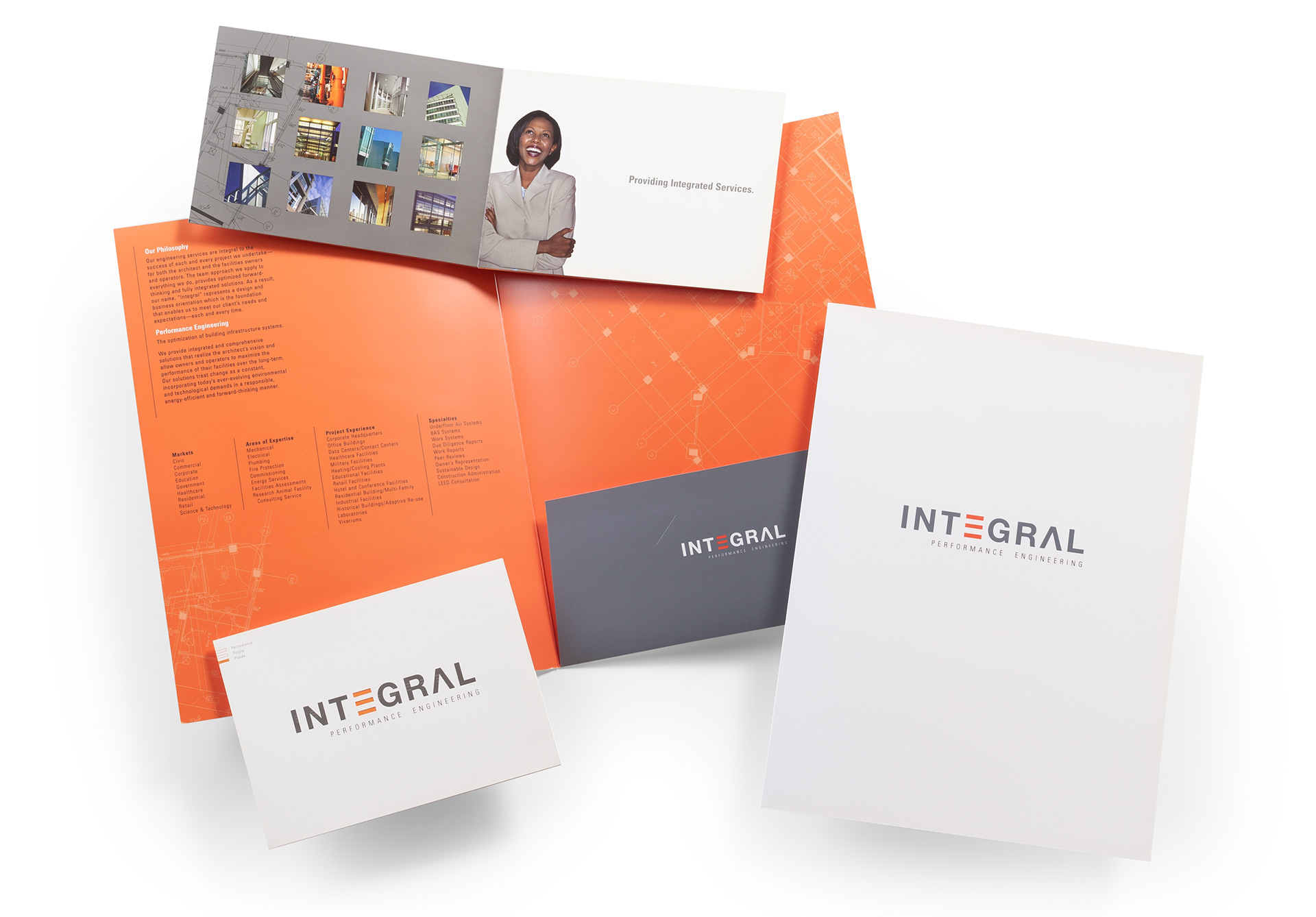 Corporate identity and print collateral designed for Integral Engineering, featuring a custom presentation folder, brochure, and branded stationery. The composition showcases the distinctive three-bar E logo, architectural photography, engineering-inspired graphics, and a coordinated orange, gray, and white color palette.