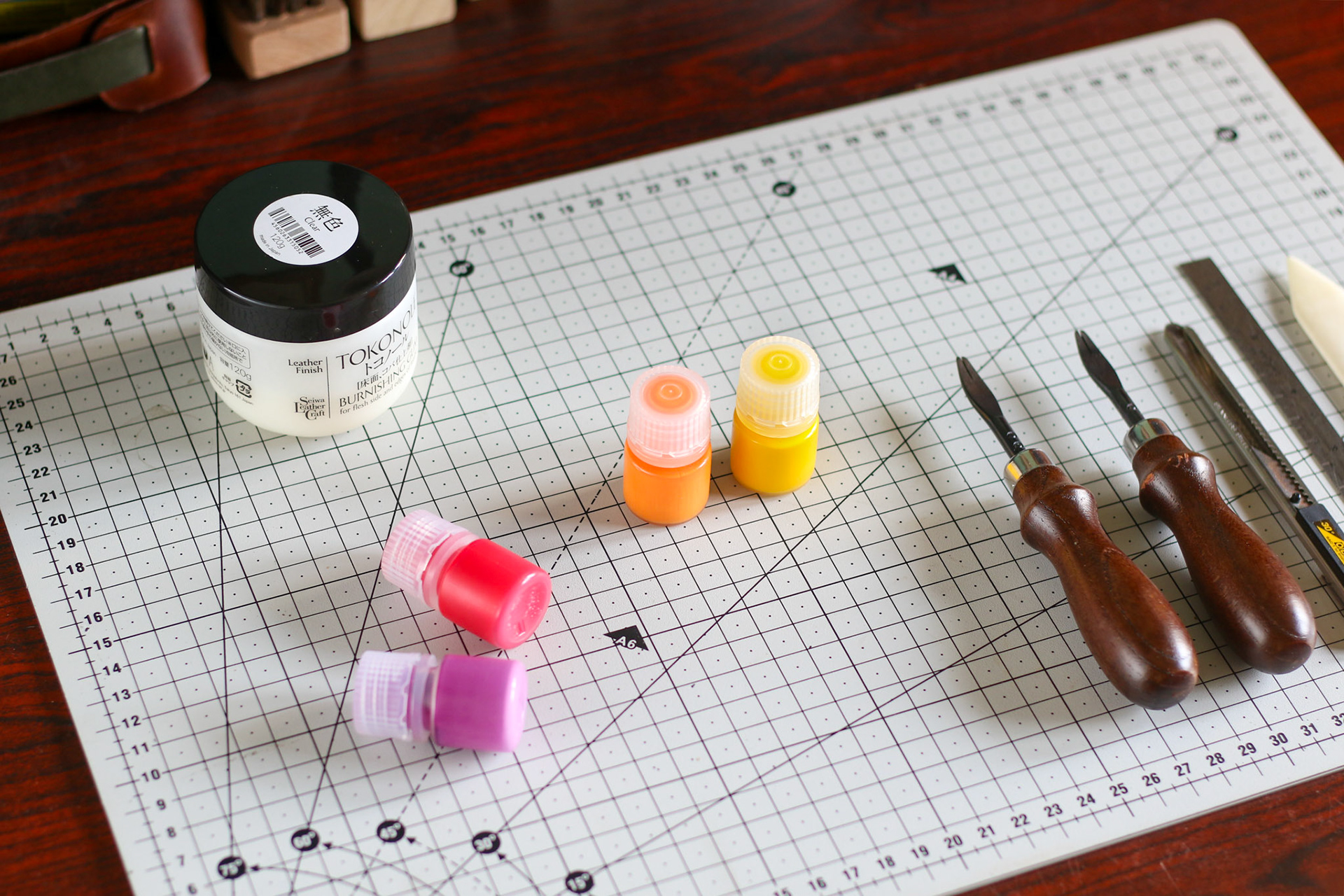 the craftsman's desk with various leather tools on it