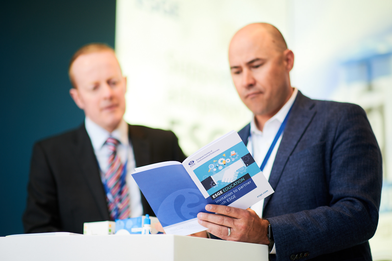Attendees looking at the conference program booklet