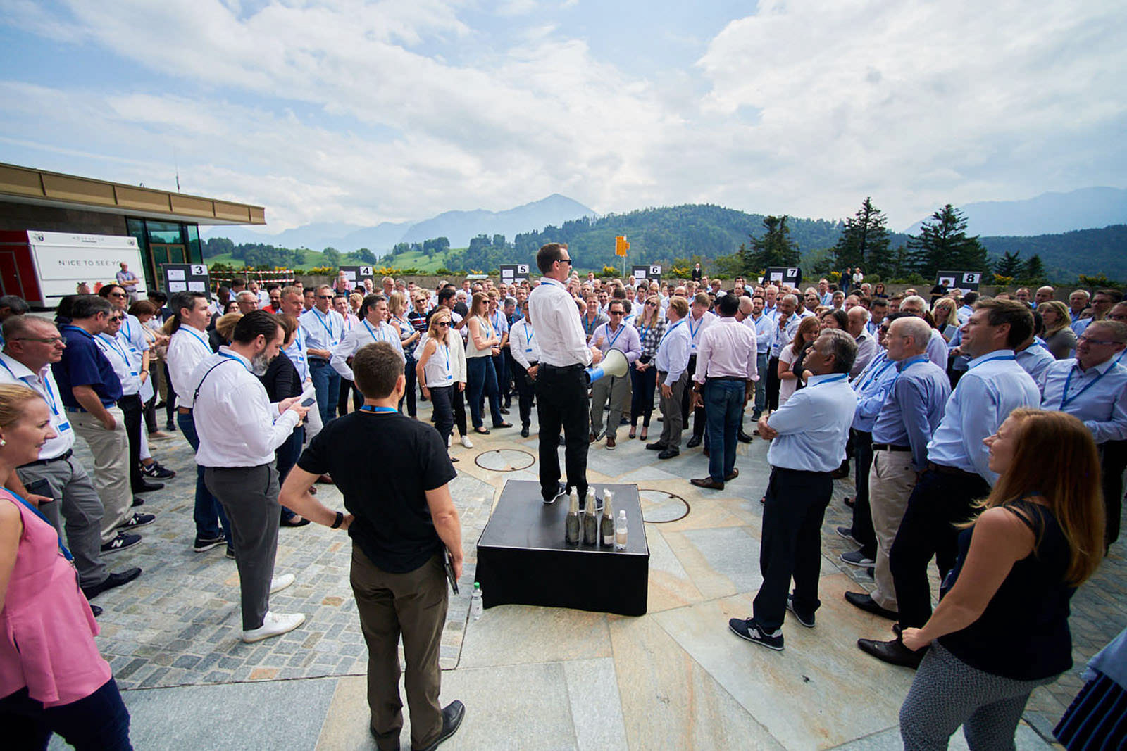 Outdoor teamwork session during a corporate leadership meeting at Bürgenstock Resort Lake Lucerne, with the spectacular Swiss mountains creating a stunning backdrop.