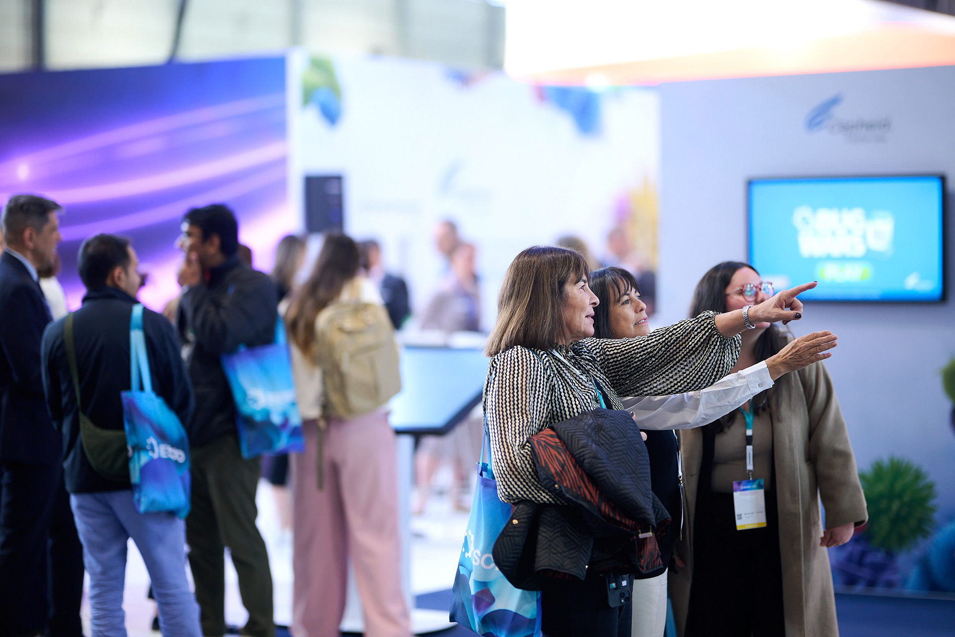 Congress visitors exploring the exhibition area among exhibitor booths