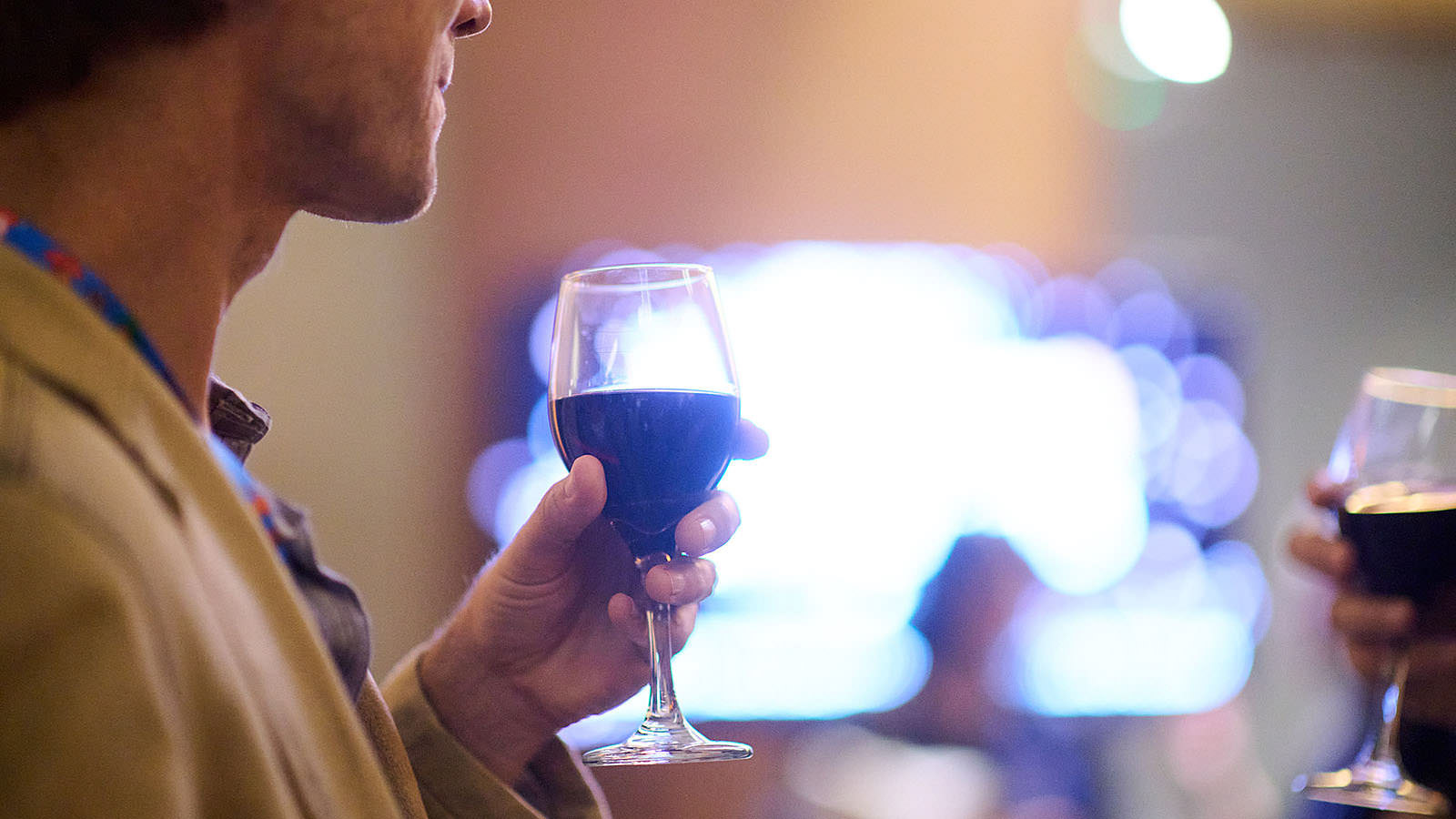 Savoring a glass of wine during a networking event.