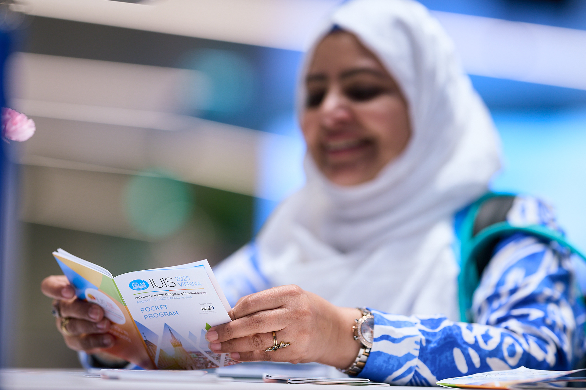 Congress attendee reading the programme at IUIS Vienna