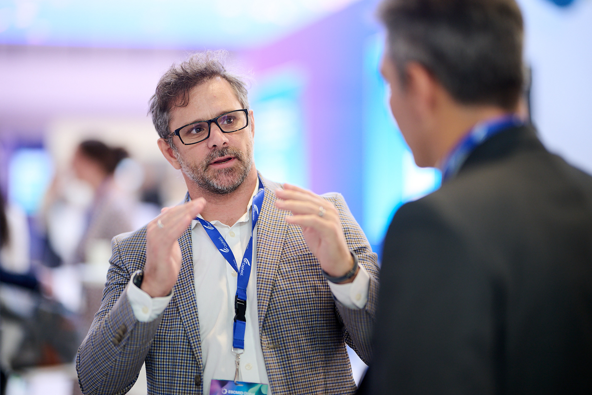 Attendees interacting and networking around exhibition booth