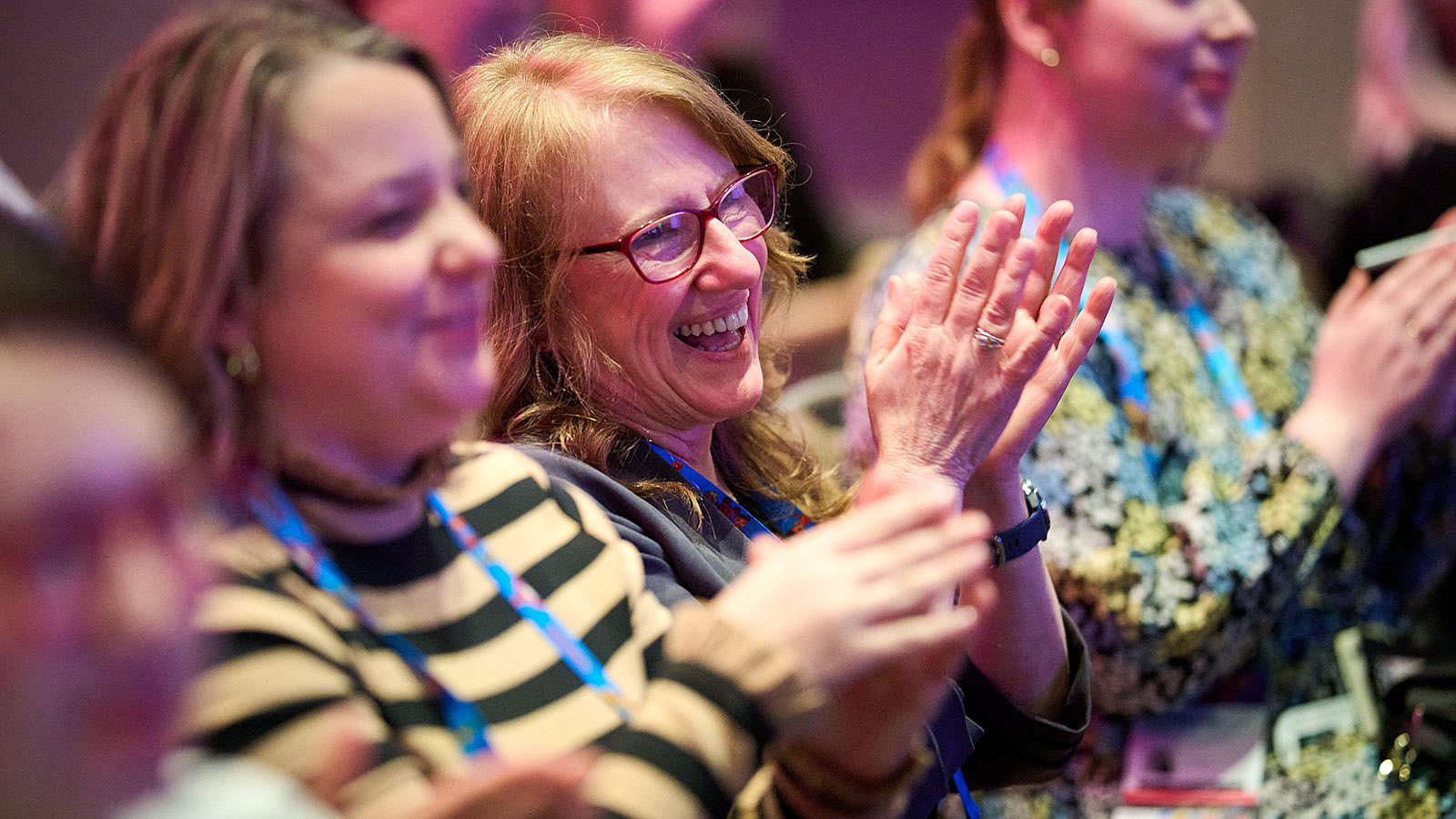 Audience showing appreciation with applause following a keynote speech.