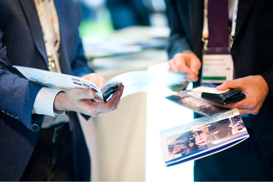 Visitors looking at branded marketing materials