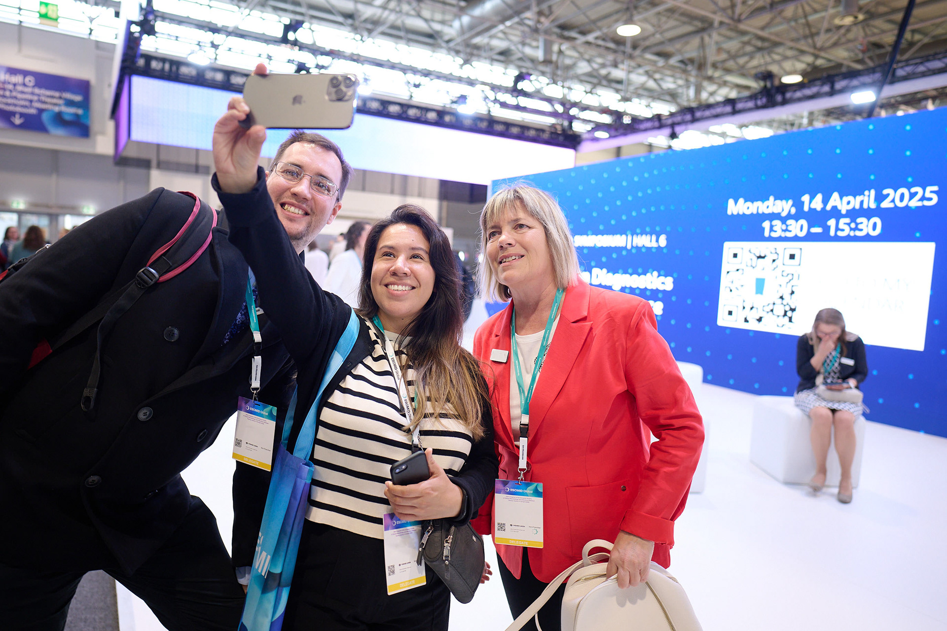Congress visitors taking selfies at exhibitor booths in the exhibition area