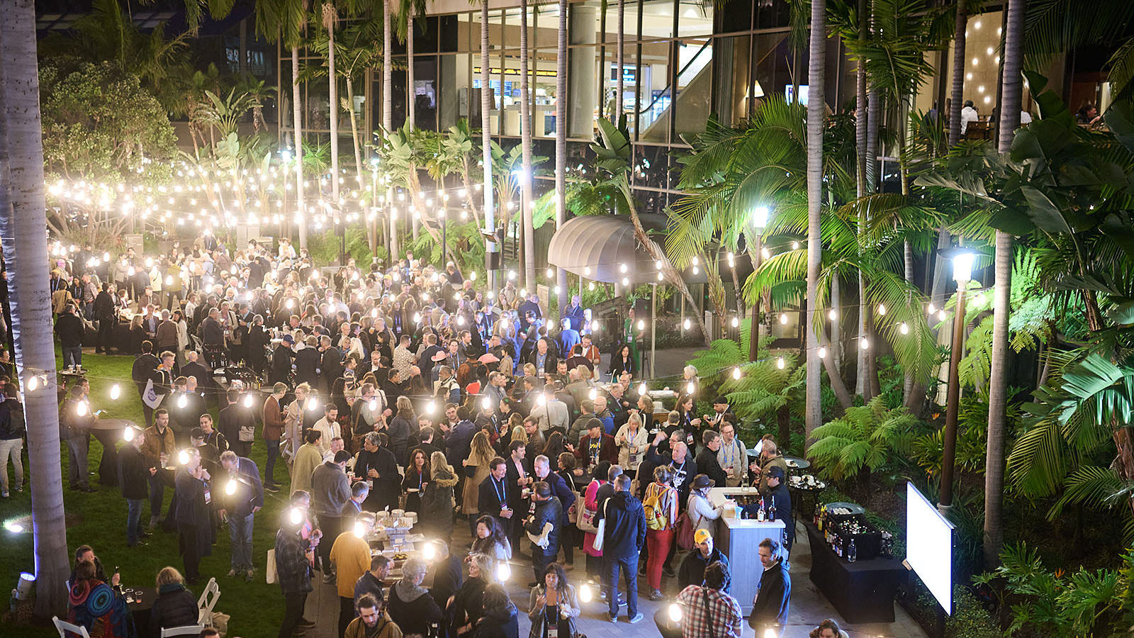 Crowded opening reception with numerous attendees.