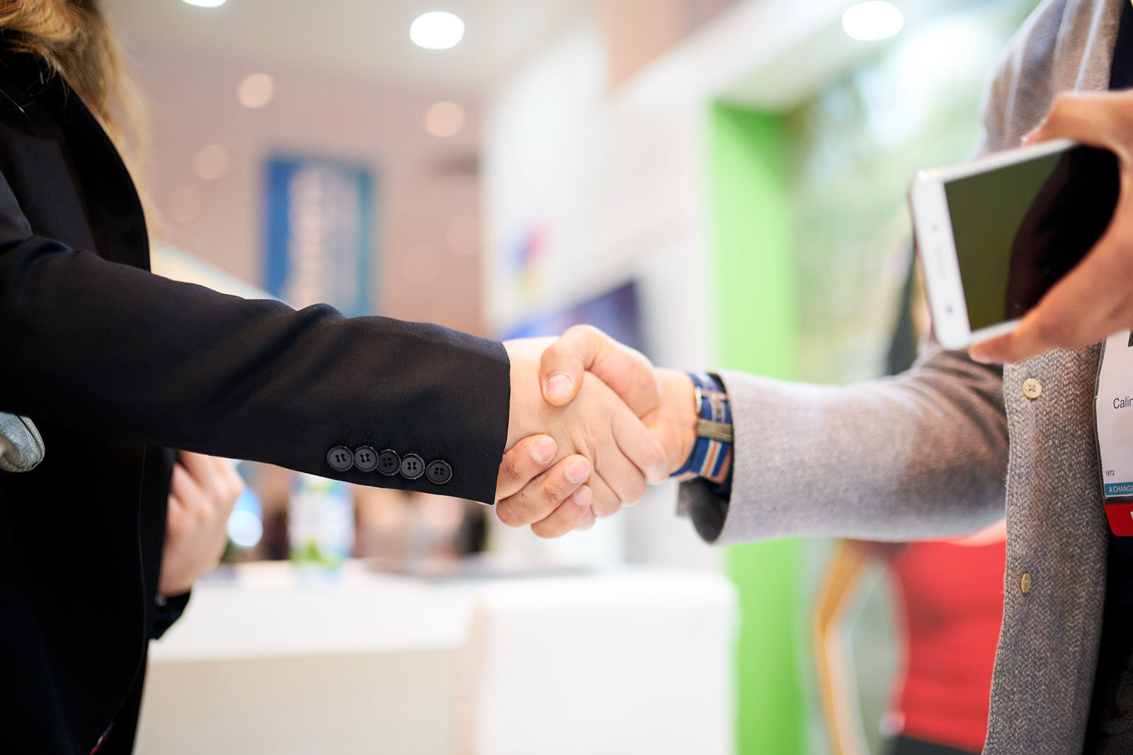 Photo capturing a handshake during a meeting.