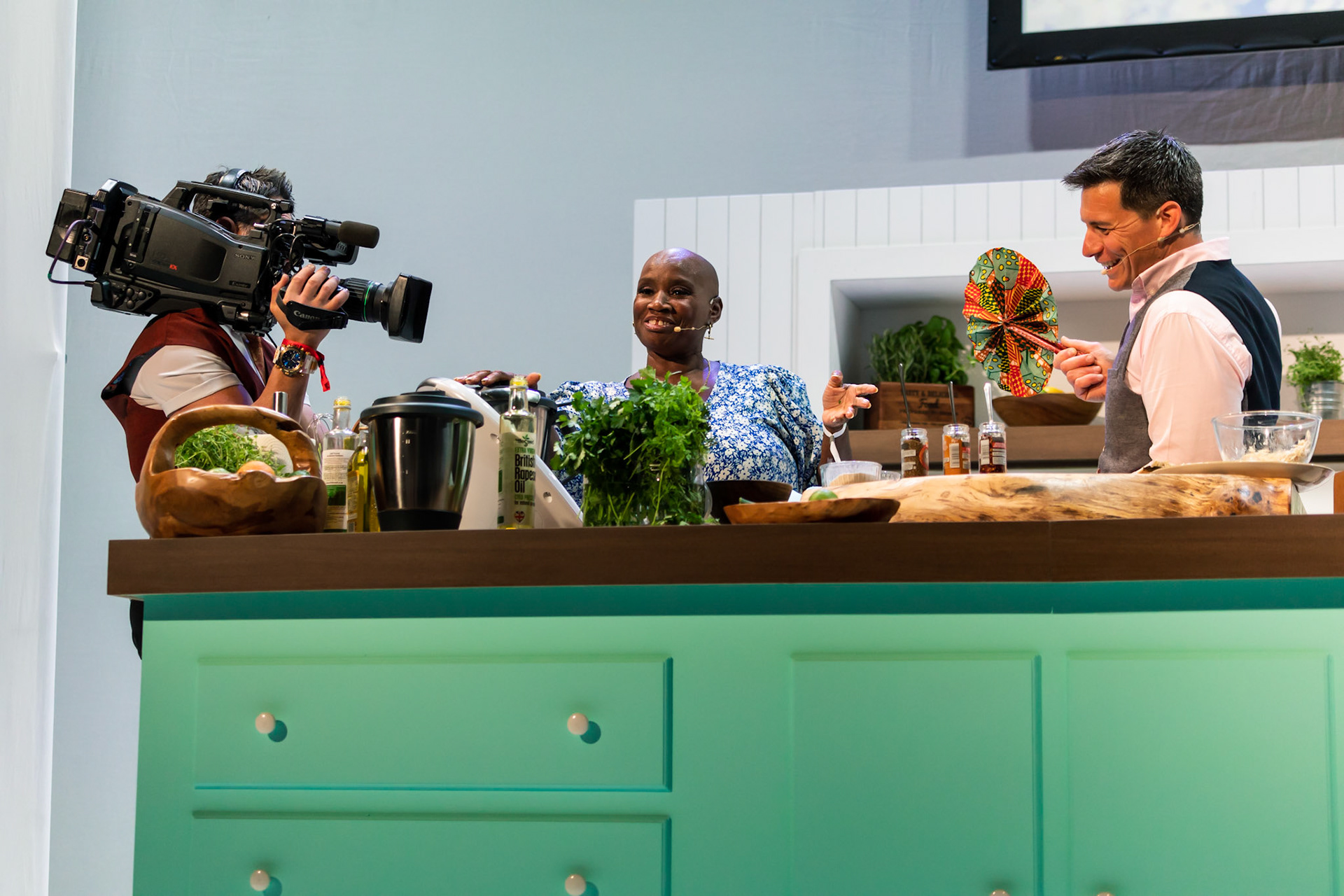 Andi Oliver cooks white sweet potato & saltfish fritters, ackee cream & green seasoning oil live in the Big Kitchen at the BBC Good Food Show Summer, hosted by Marcus Bean, 16th June 2022