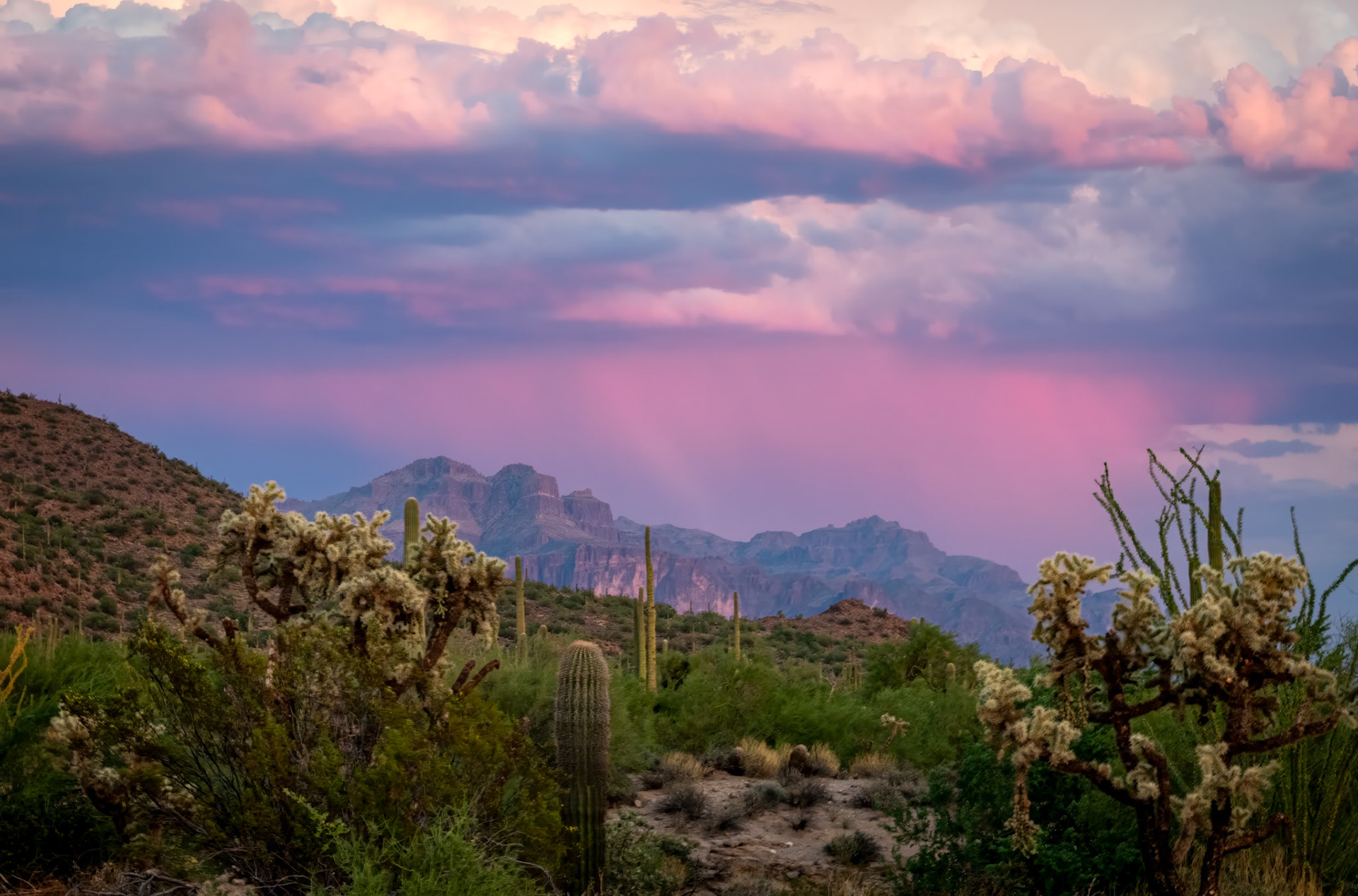 Stormy Desert Mountain Sunset - Sometimes the opposite side of a sunset can be just as beautiful.  Captured at Usery Mountain Regional Park.  A storm was brewing over the mountains opposite the sunset and provided this amazing vista.