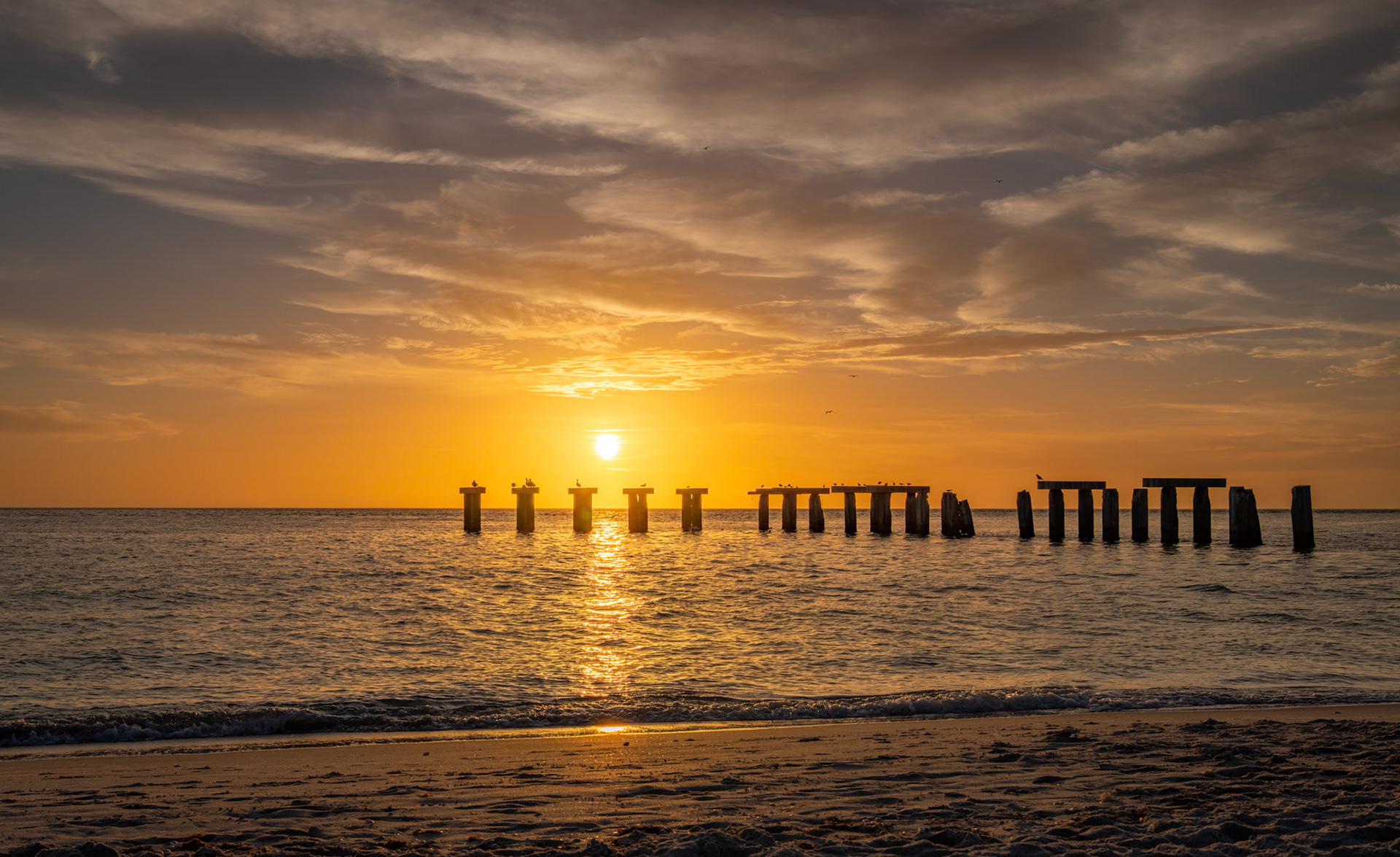 Bocahenge Sunset - from the beach in Gasparilla Island State Park.  The pilings are from an abandoned stone fisihng pier called Bocahenge.  Boca Grande is the main town on this island.