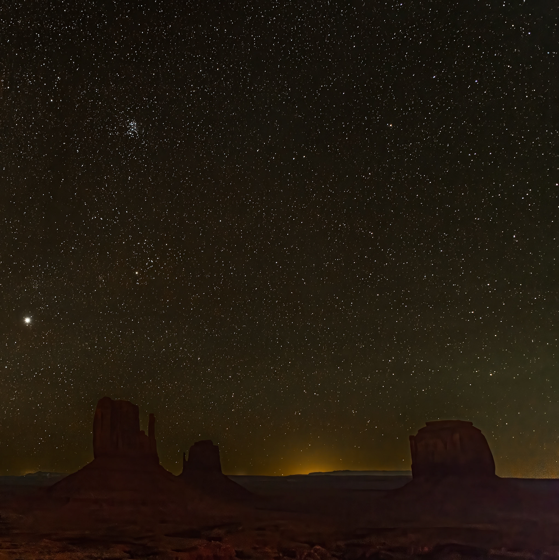 Starry Night Over Monument Valley - This easterly night view of Monument Valley reveals the back side of a late season, late evening Milky Way.  The Milky Way's core has already set on the western horizon. 