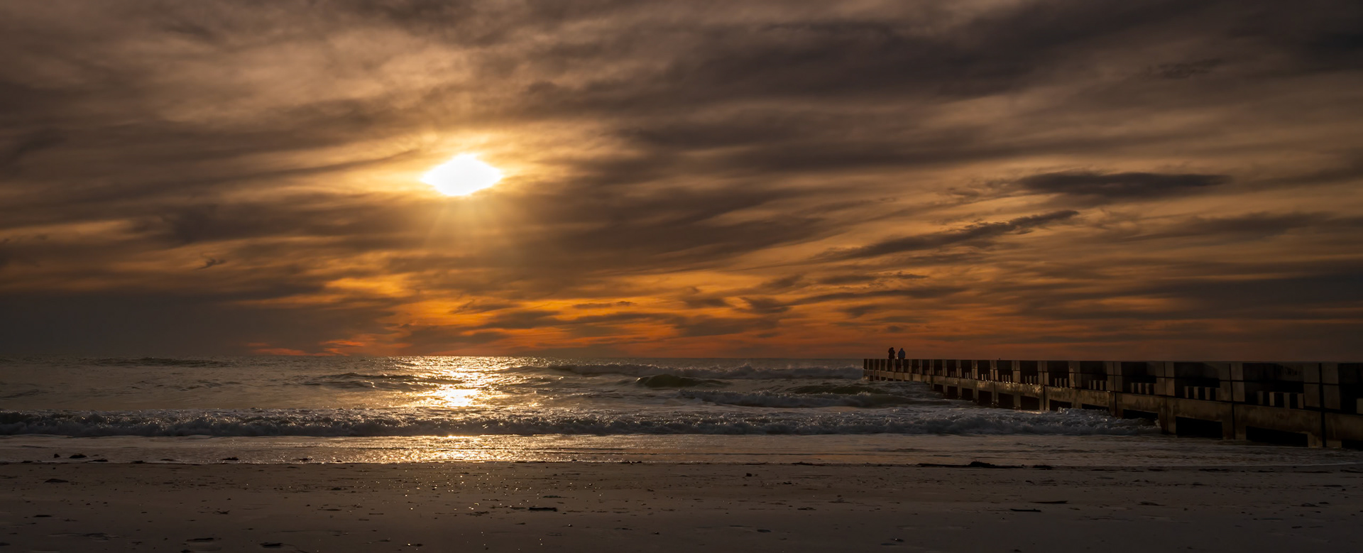 Evocative sunset over the Gulf of Mexico and Cortez Beach on Anna Maria Island, Florida