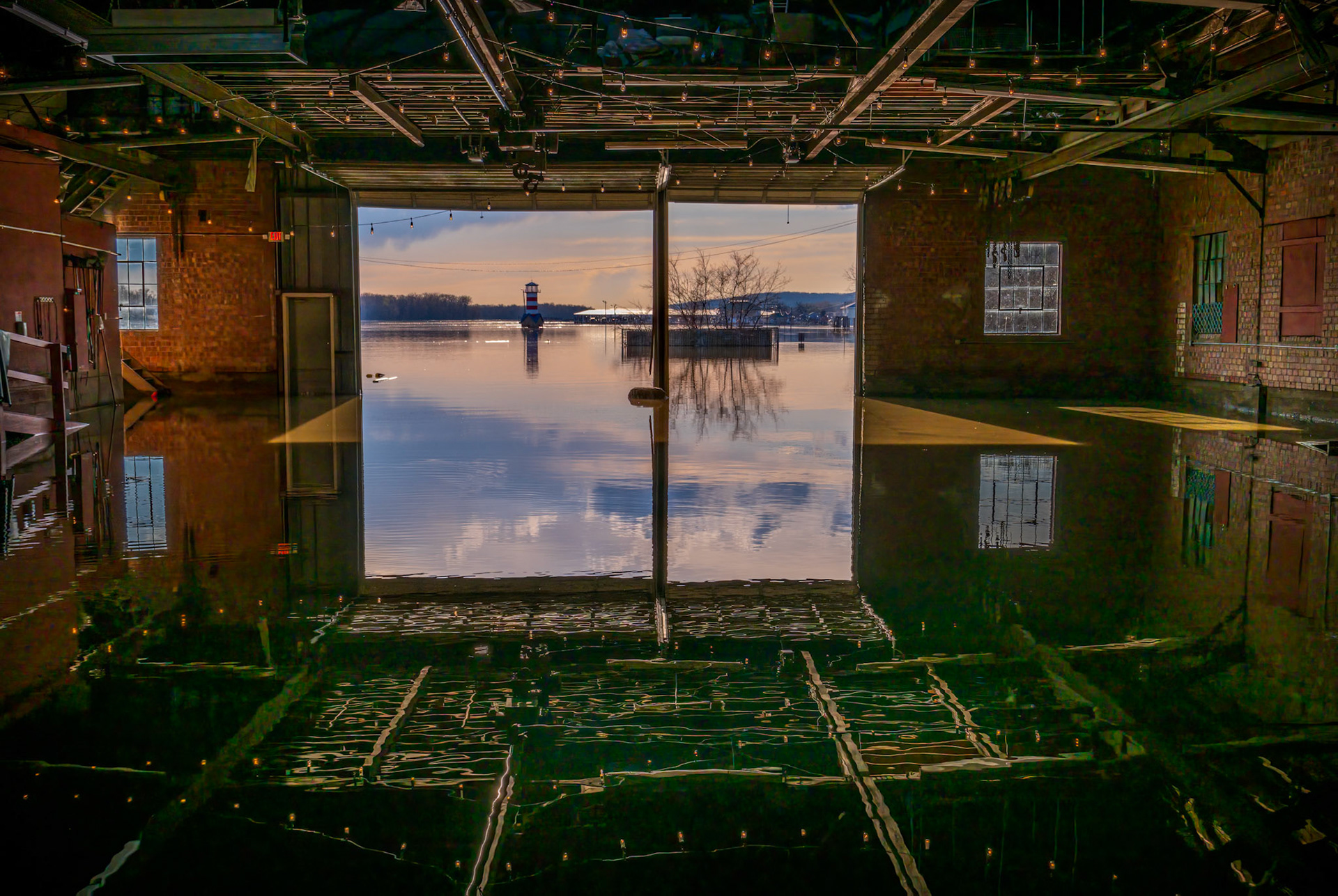 Reflections On A Flood - Sunset and reflections on the Mississippi River flood waters in the Loading Dock event space in Grafton IL