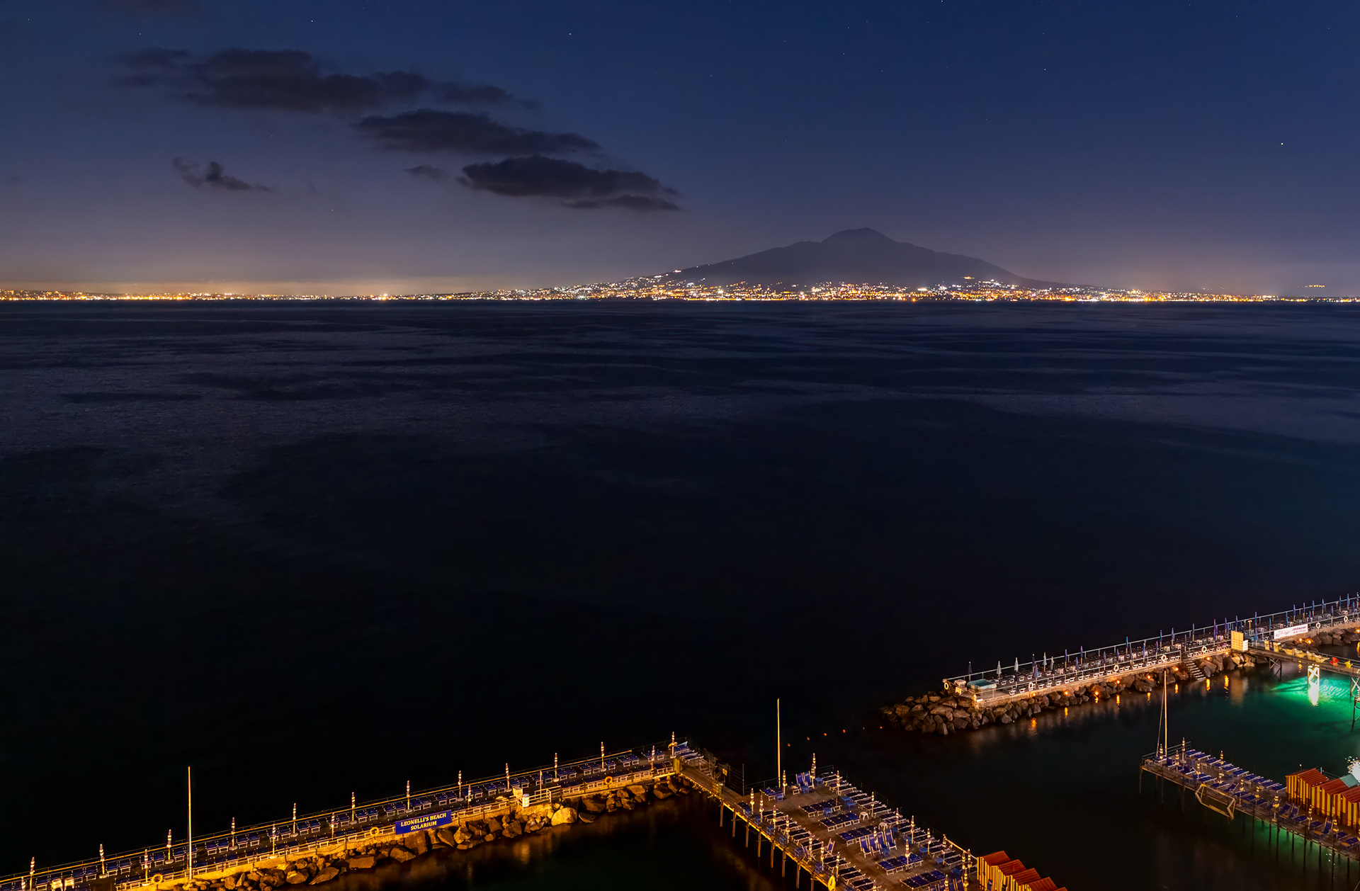 Evening On The Gulf of Naples - View from Sorrento across the Gulf of Naples with the Naples metro area coastline and Mount Vesuvius in the background