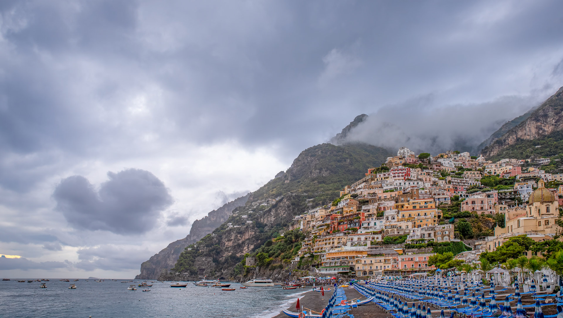 Moody Day on the Amalfi Coast - Positano's beach, Spiaggia Grande, cliffside buildings and surrounding hillsides grace the Mediterranean Sea.