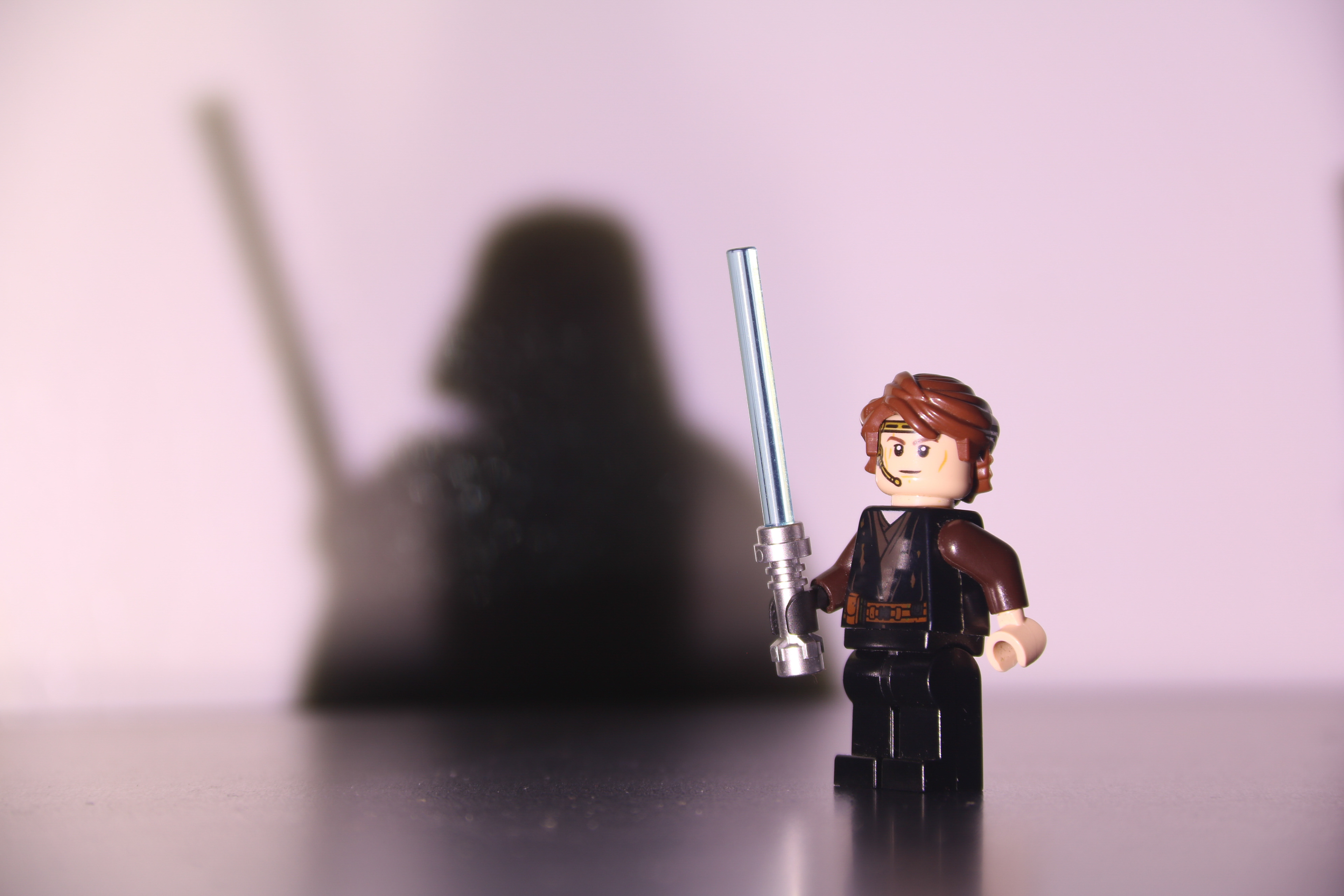 This image is not at all digitally altered--the Darth Vader minifigure is just extremely carefully positioned to be outside of the frame while still casting its iconic shadow.