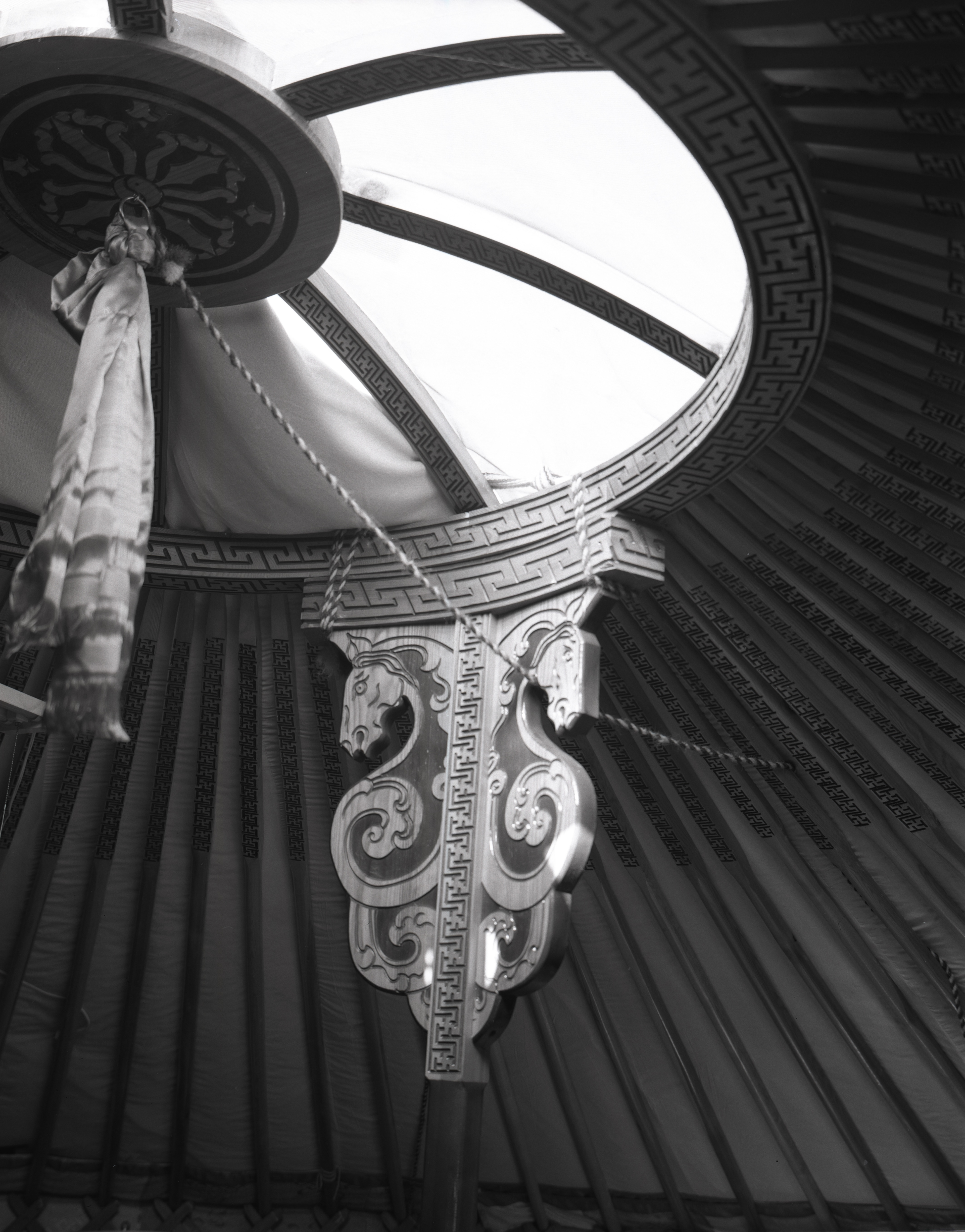 The sun is shining on top of the ger, lighting up its interior